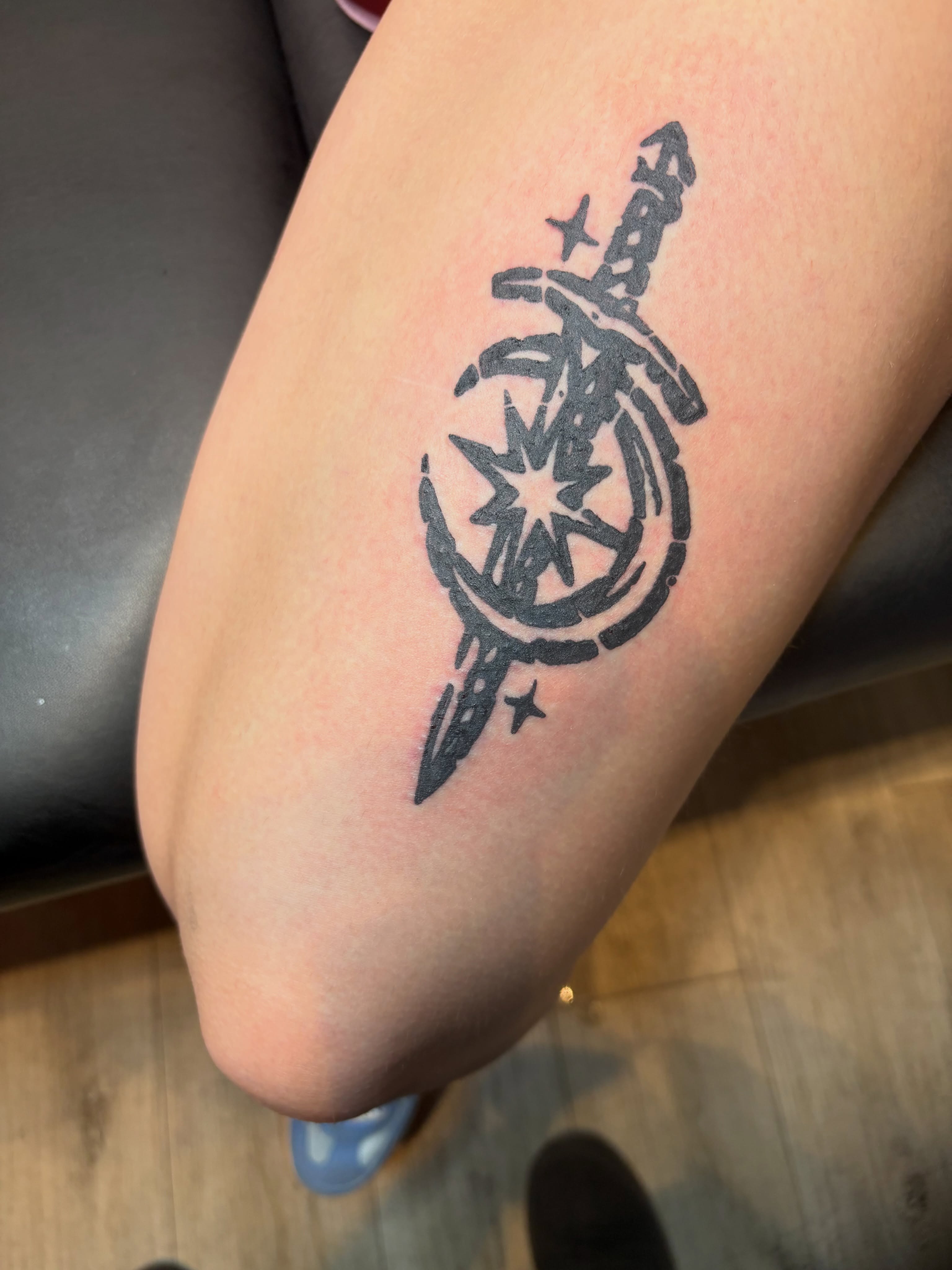 Sword and star black and grey tattoo on the forearm by Calen Copeland
