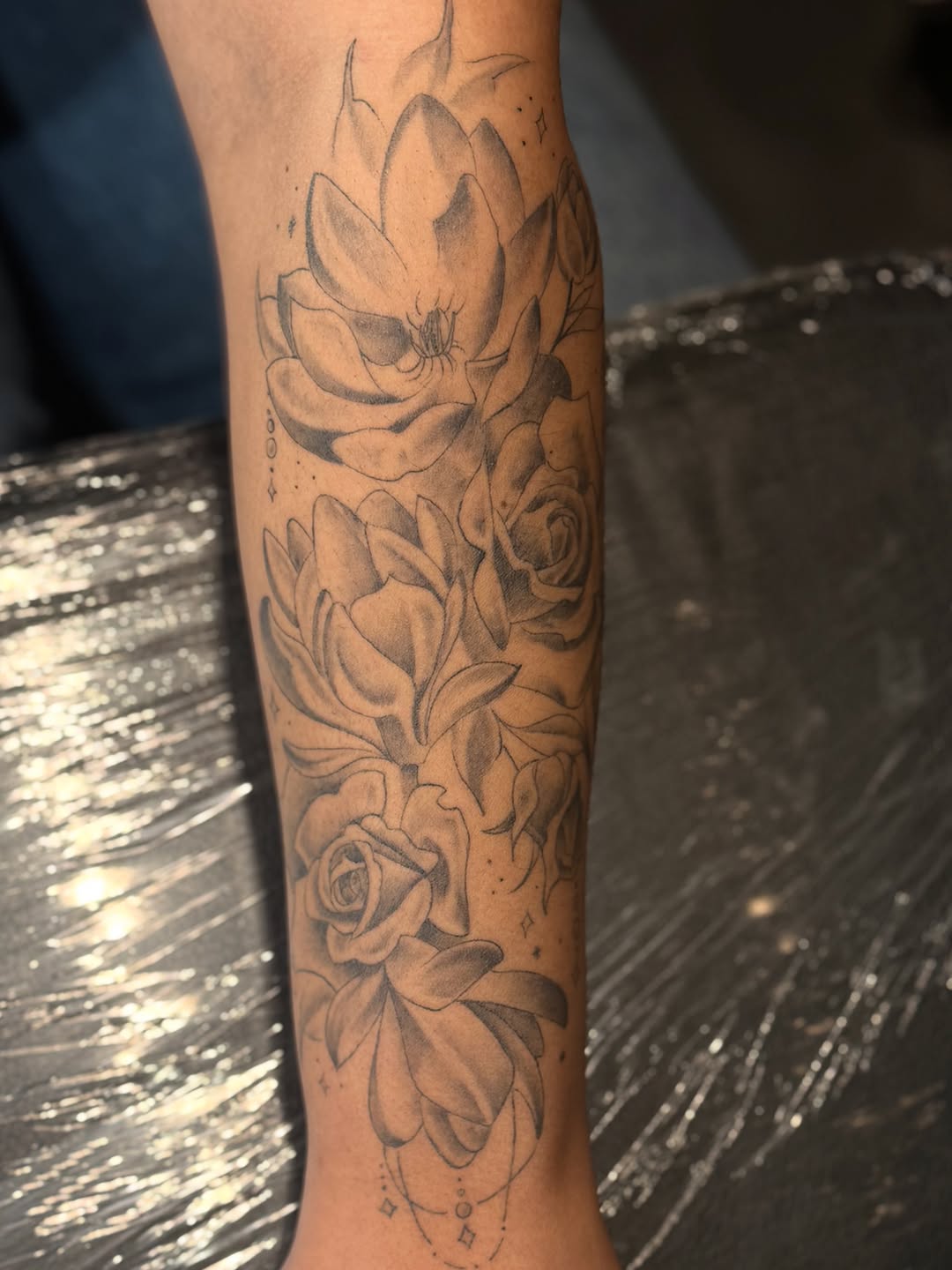 Floral arrangement fine line tattoo on the forearm by Justin McDaniel