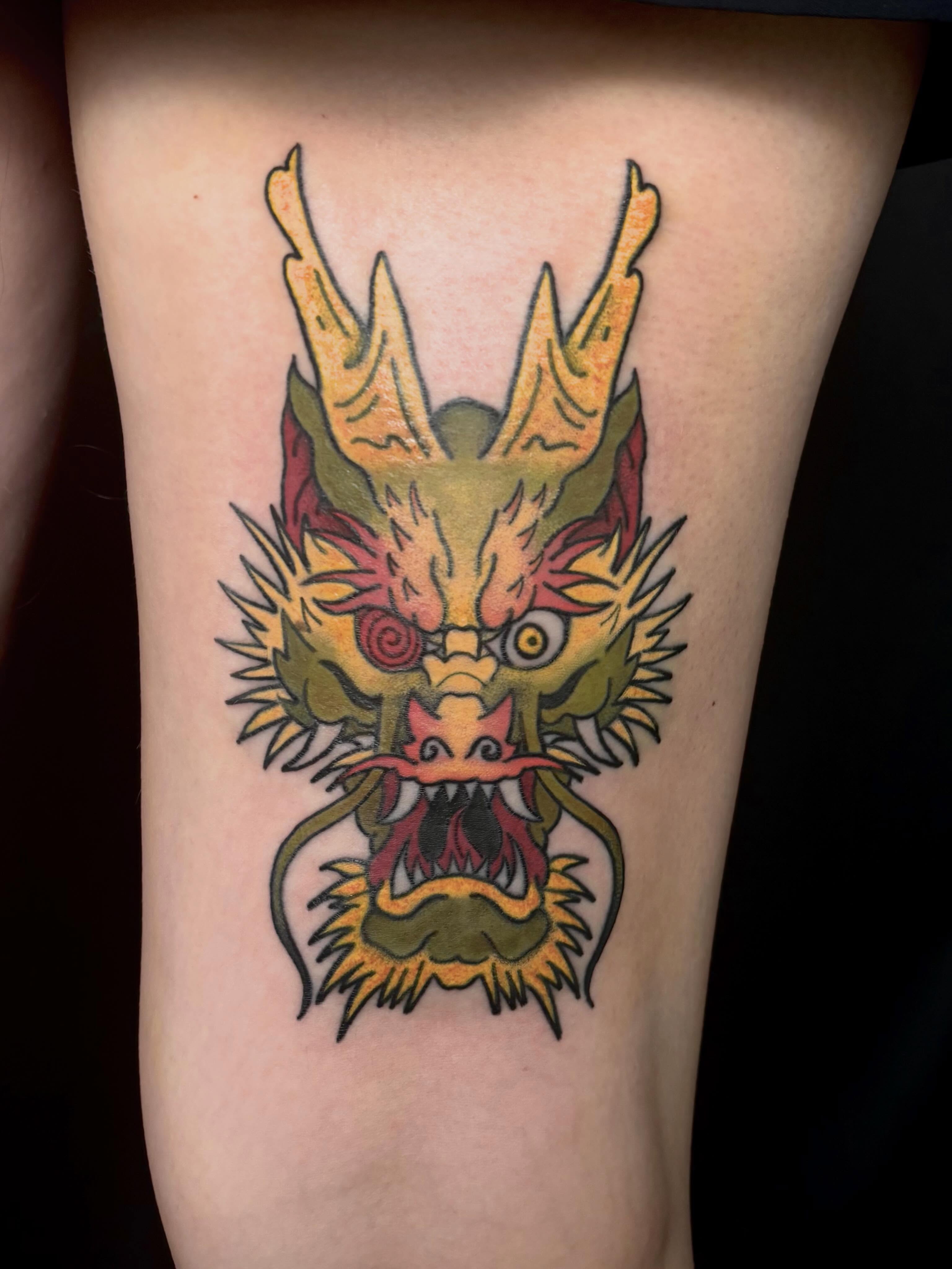 Dragon head American traditional tattoo on the forearm by Erica McCullough