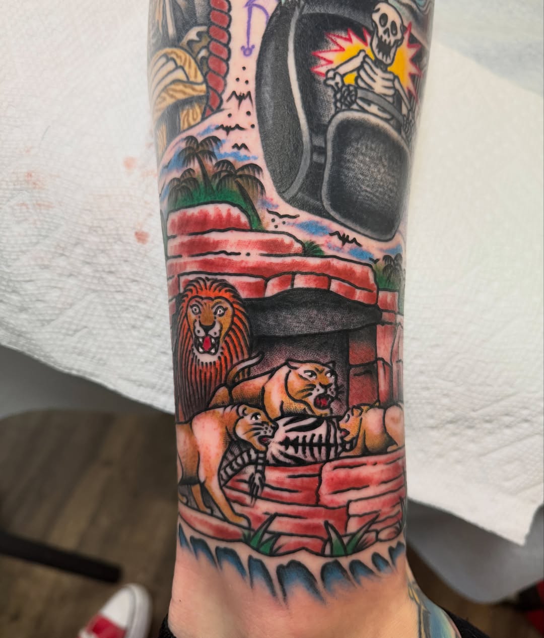 Lion and tiger American traditional tattoo on the forearm by Brandon Bear