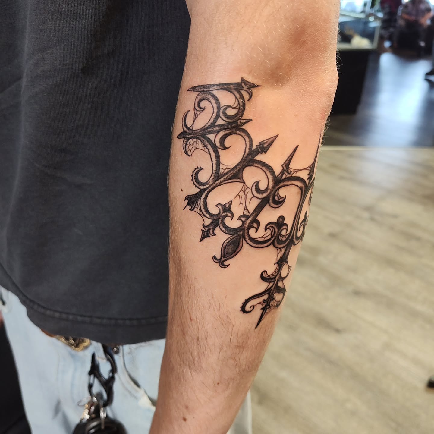 Scrollwork ornamental tattoo on the forearm by Mercury