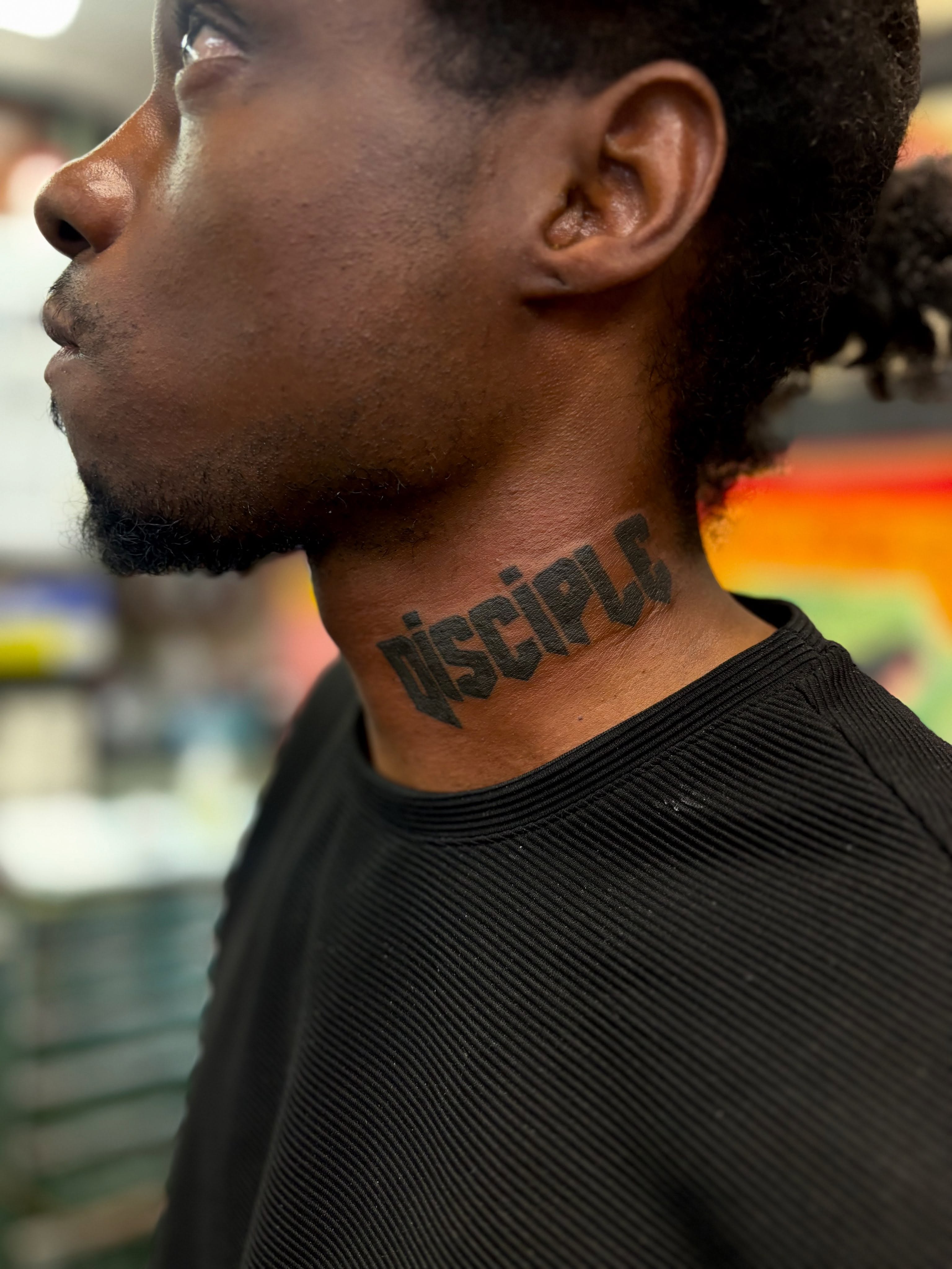 Disciple lettering script tattoo on the neck by Columbus tattoo artist
