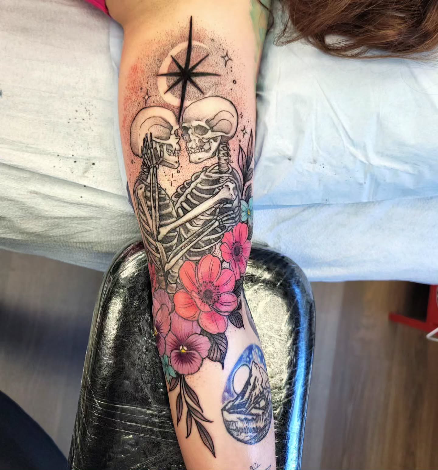 Skeleton couple with flowers dotwork tattoo on the forearm by Chantel Chan, Portland, Oregon