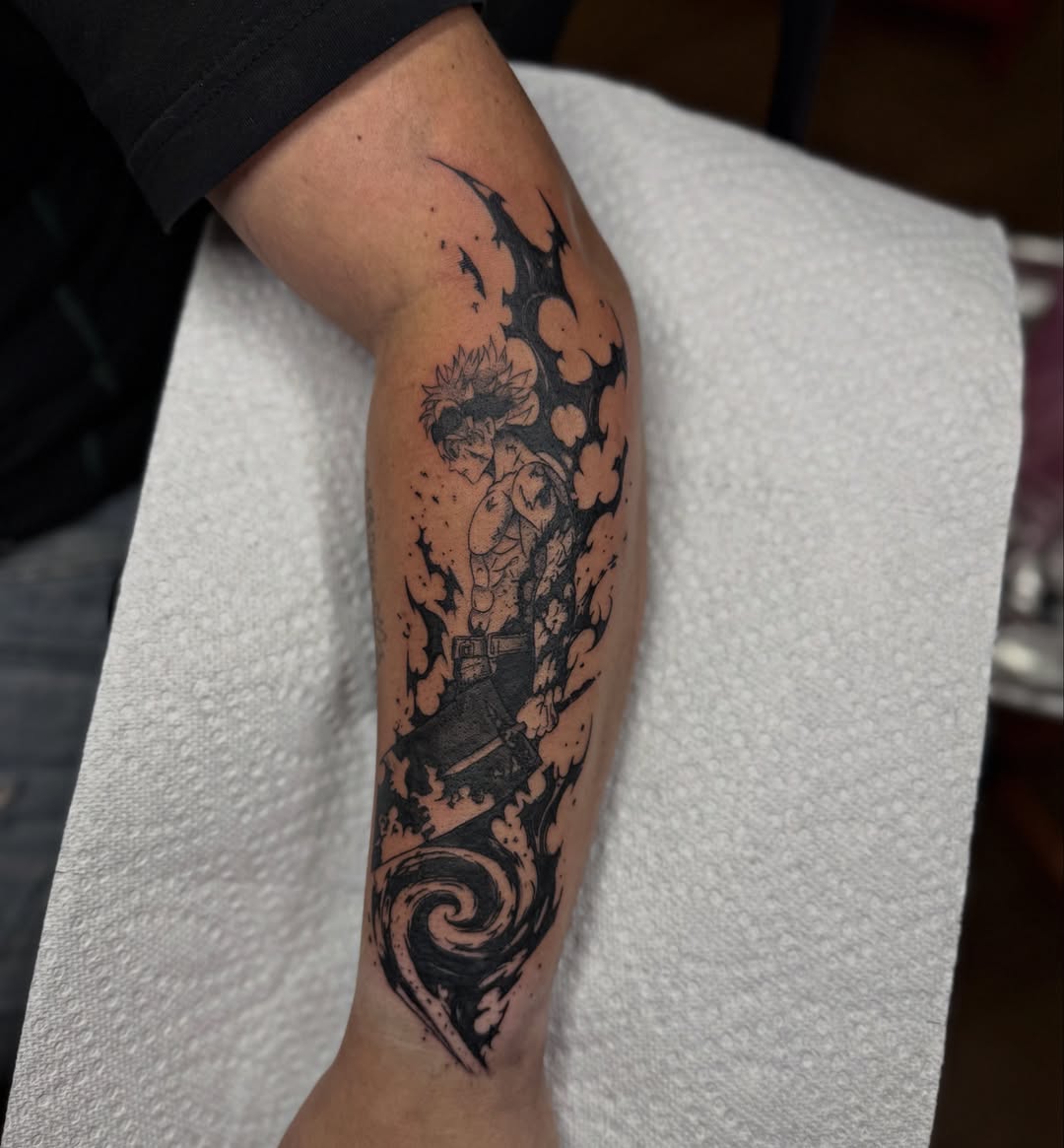 Action figure black and grey tattoo on the forearm by Skylar Sheeley