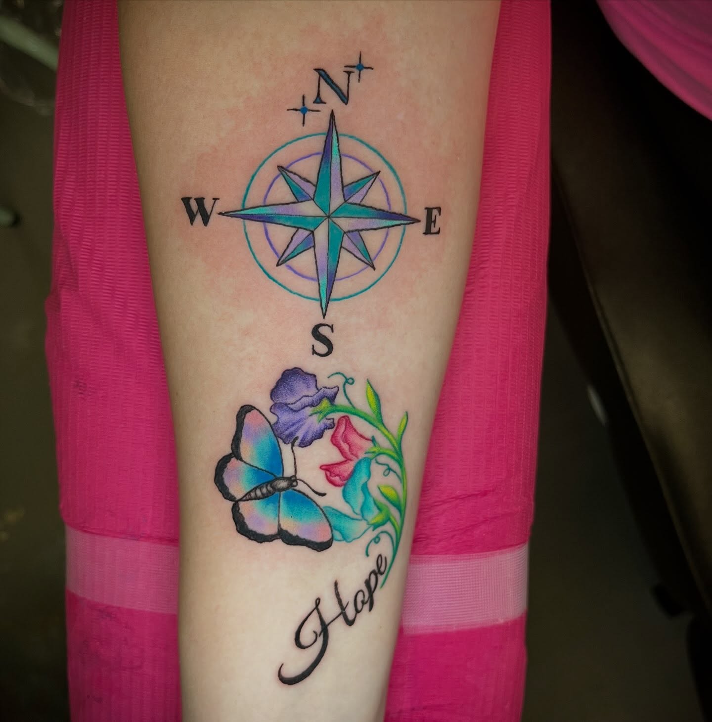 Compass and butterfly geometric tattoo on the forearm by Ash Wheeler