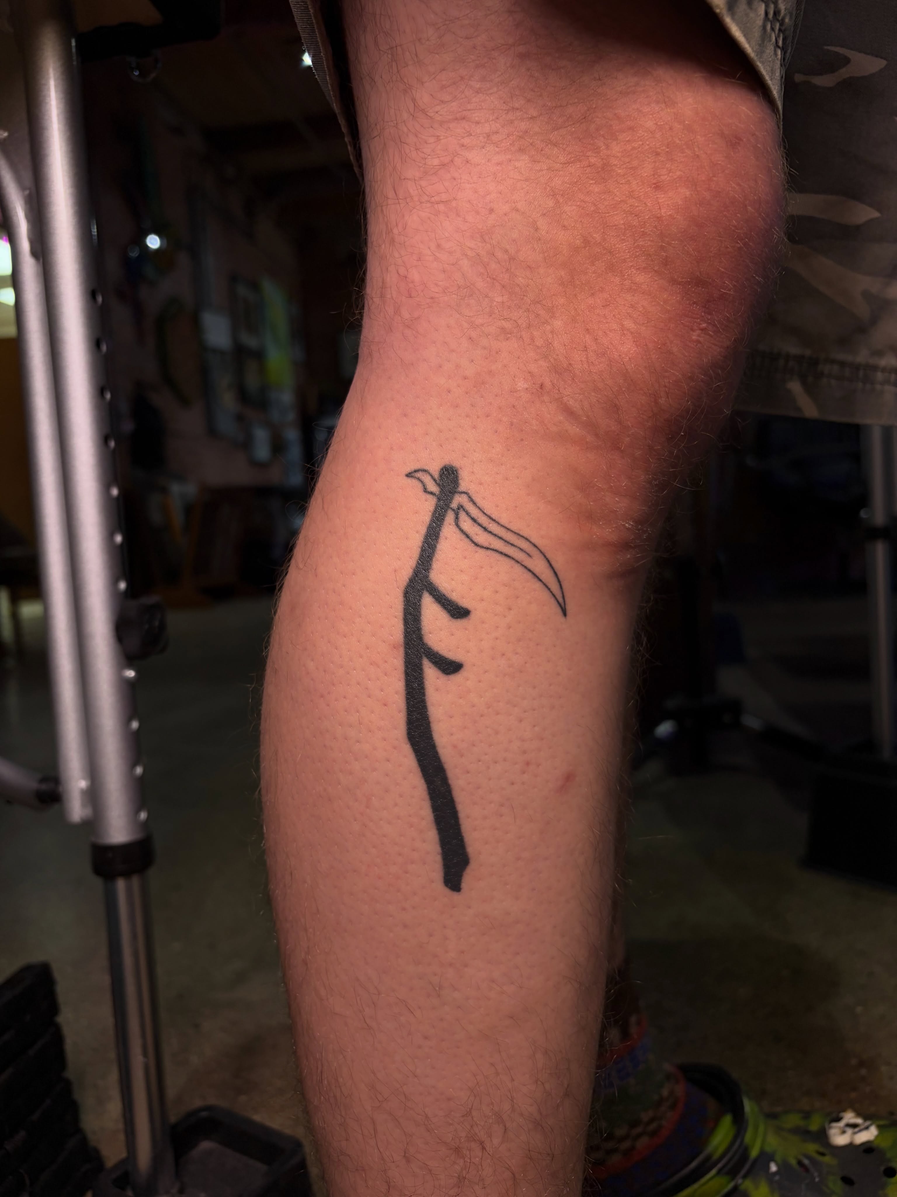Scythe minimalist tattoo on the forearm by Musa Selman