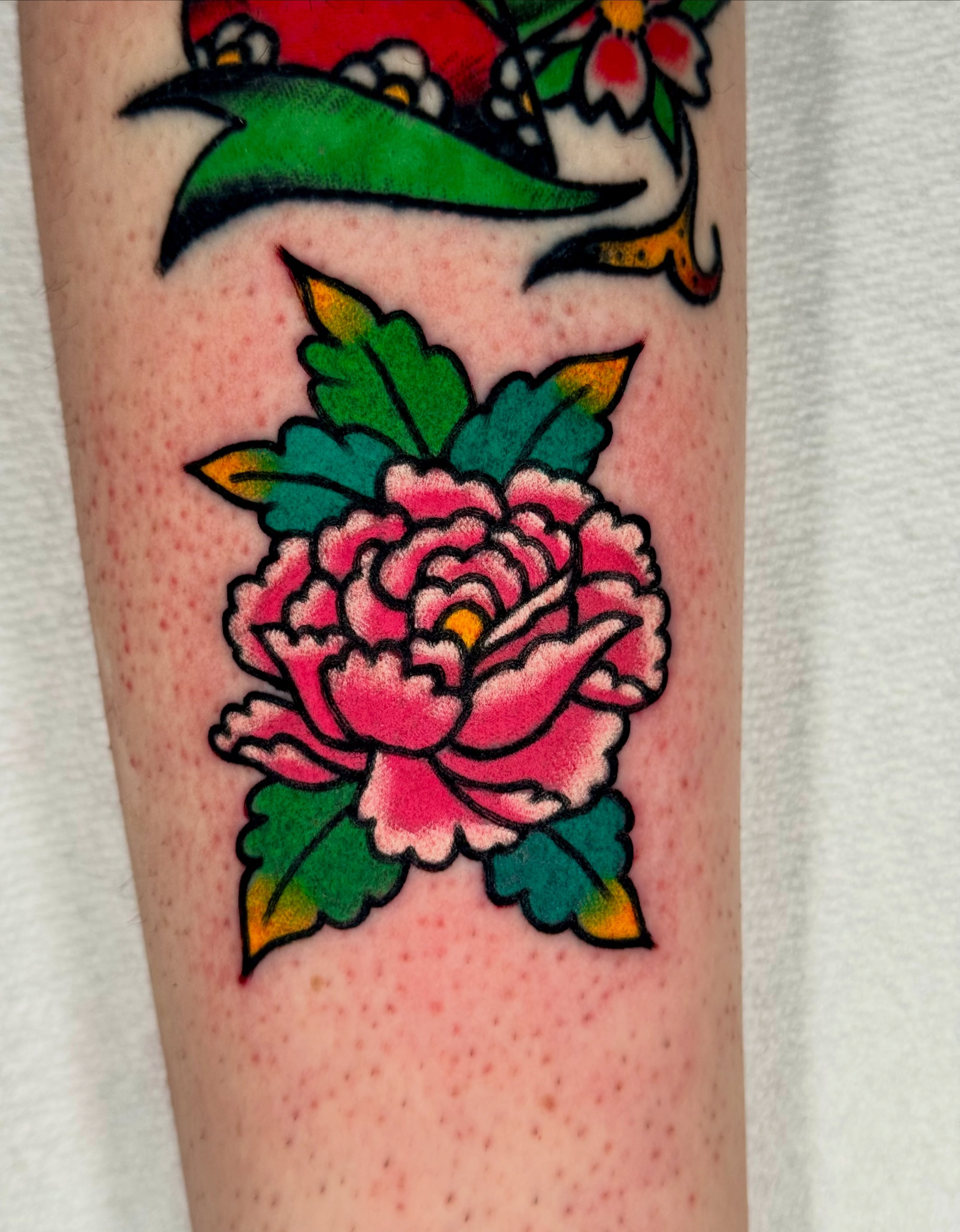 Peony American traditional tattoo on the forearm by Joe Bear Tattooer