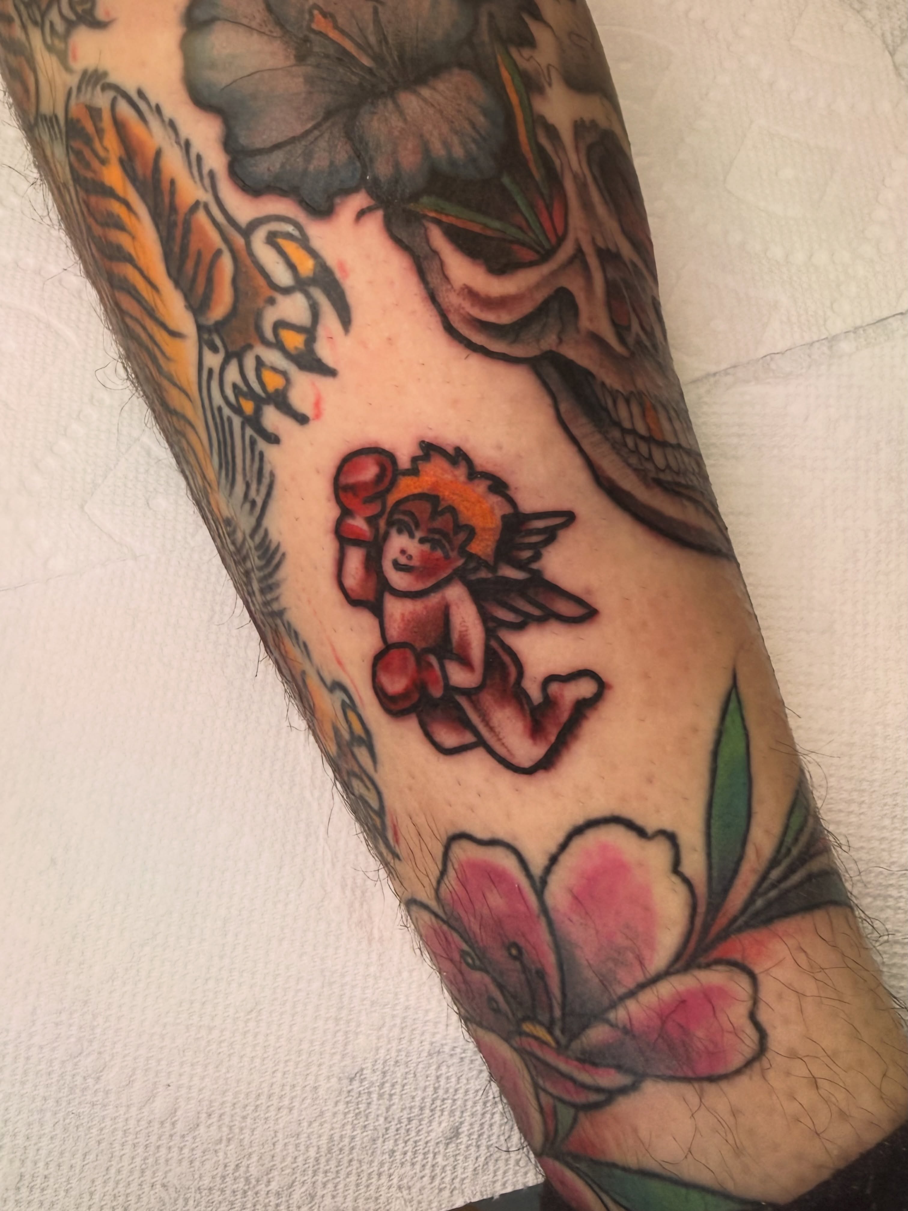Boxing cherub American traditional tattoo on the forearm by Ramón Silva