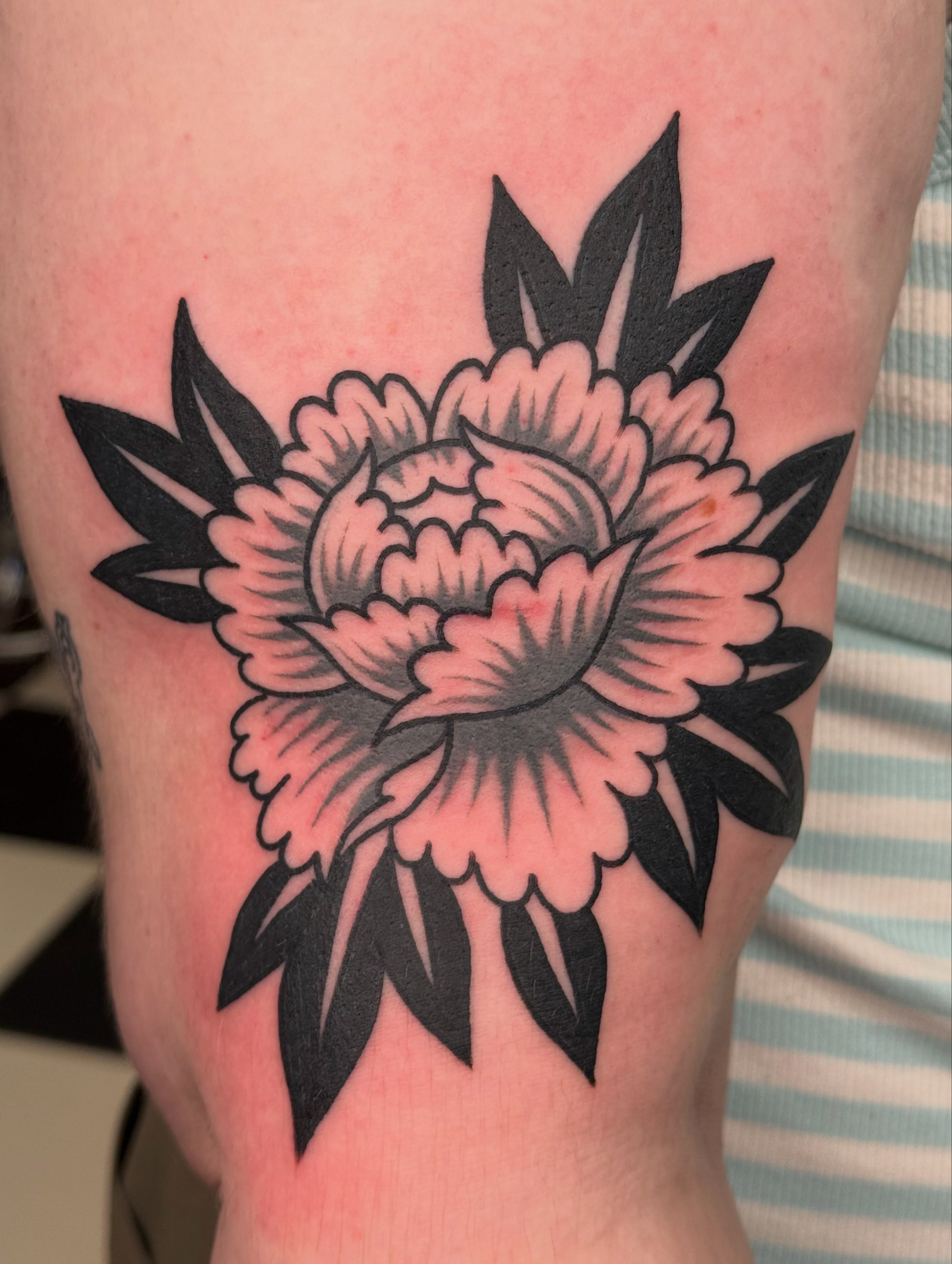 Peony American traditional tattoo on the forearm by Emma Eaton