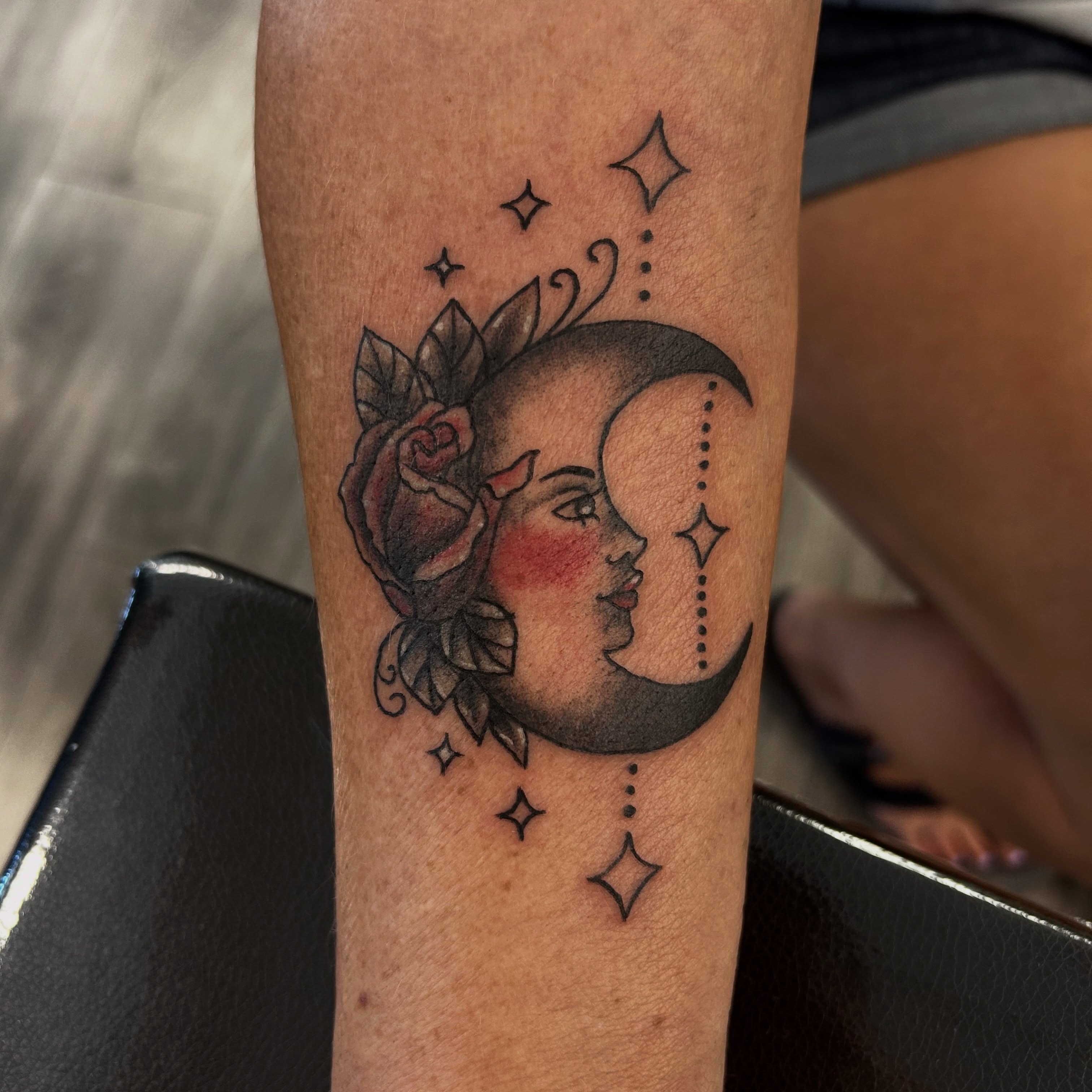 Moon and rose dotwork tattoo on the forearm by Tawni Bender