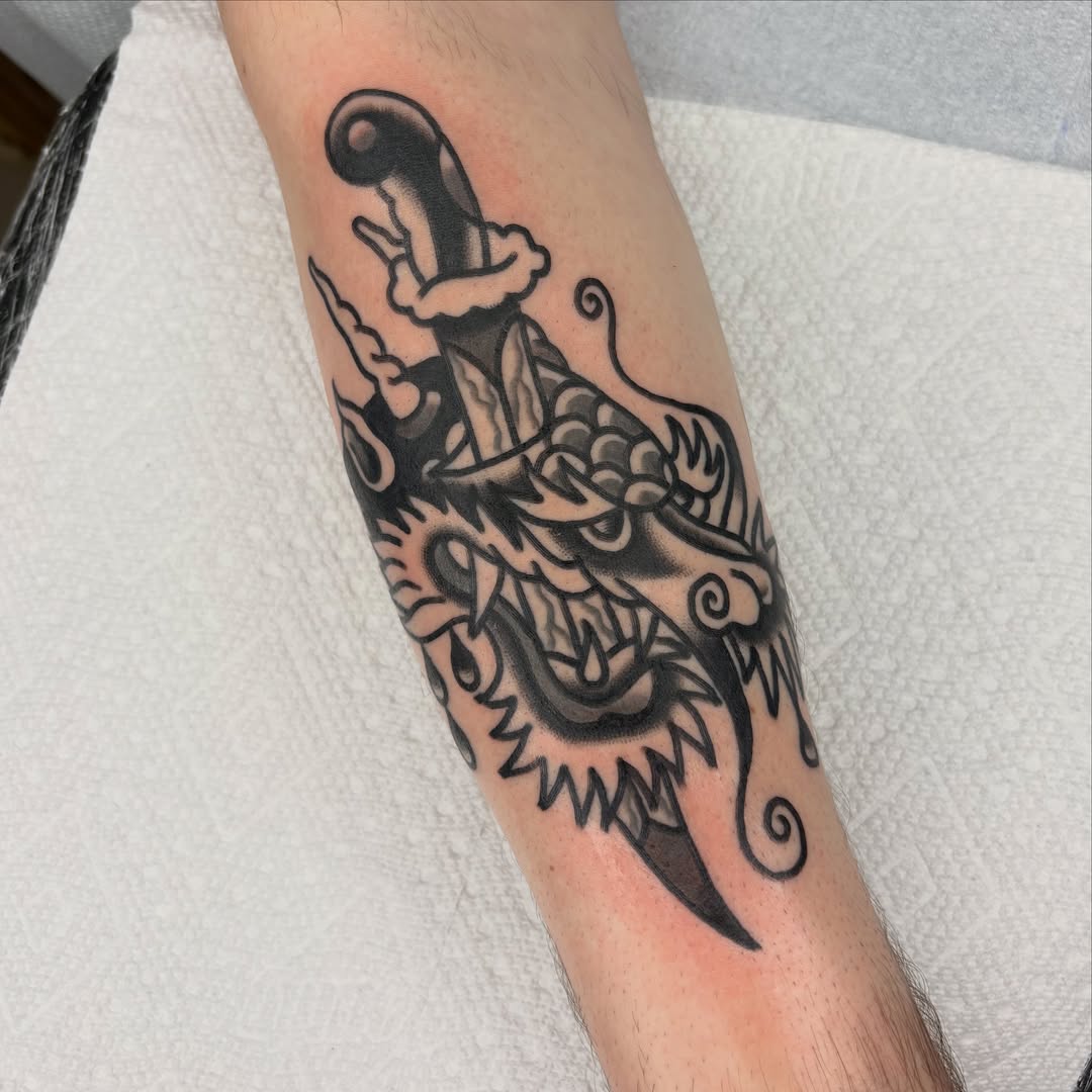 Dragon and sword American traditional tattoo on the forearm by Braedon 🎱