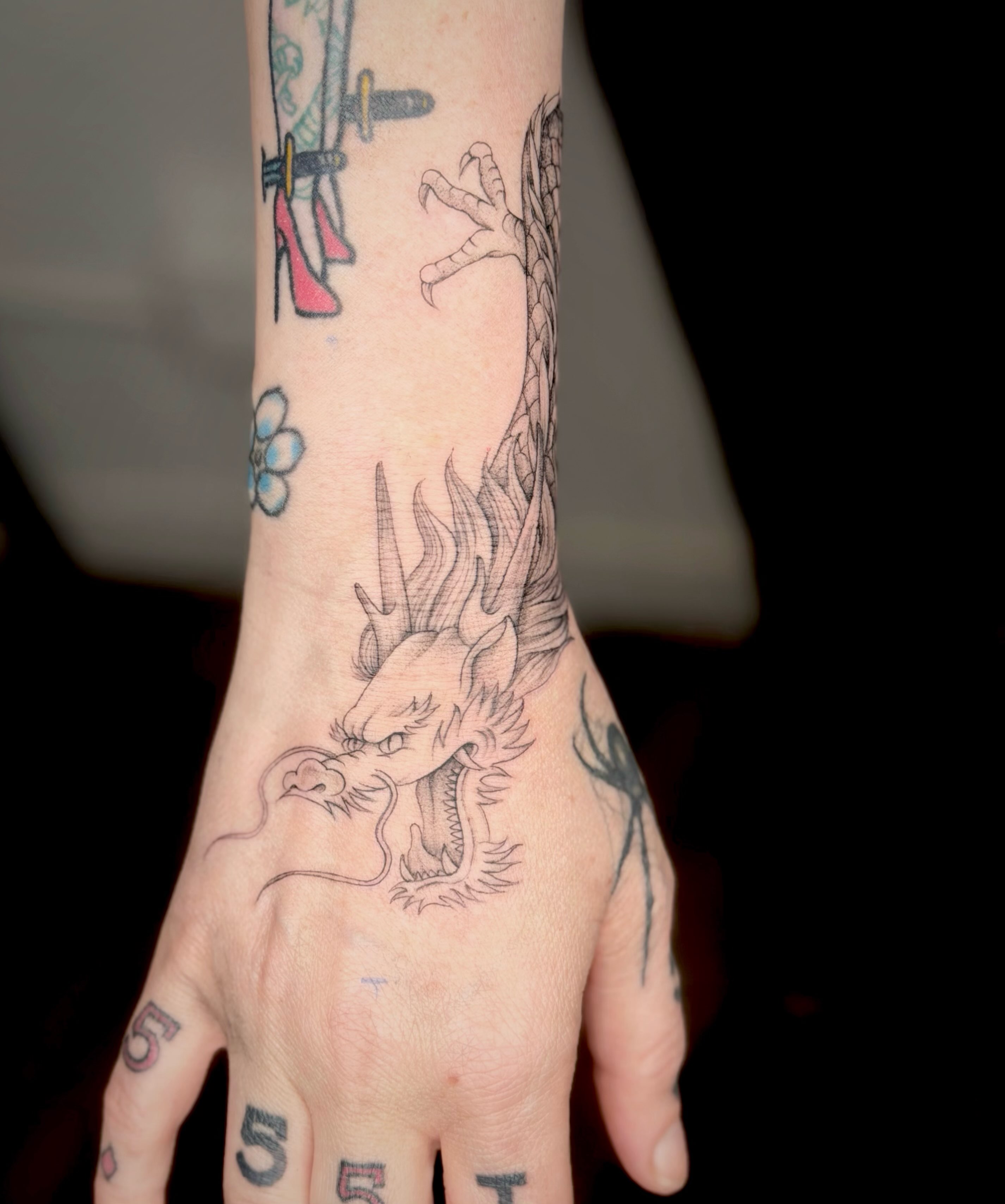 Dragon American traditional tattoo on the hand by Seattle tattoo artist-Mia