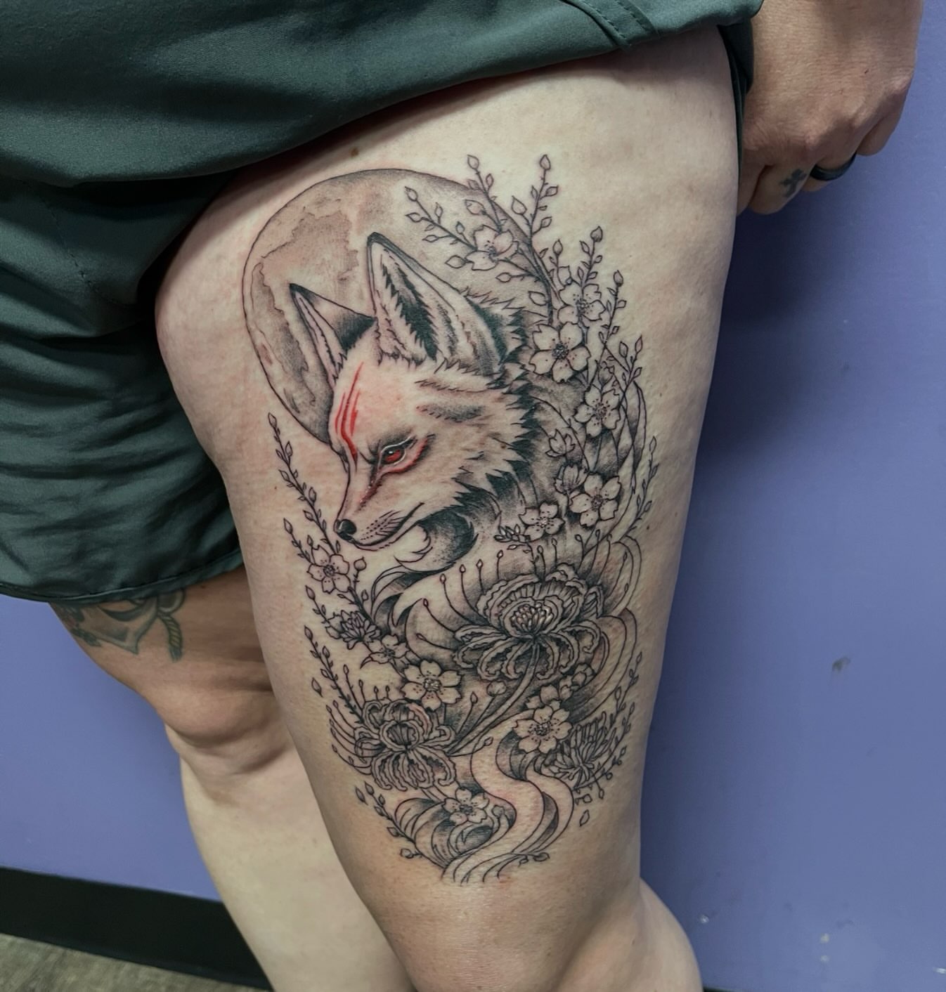 Fox and floral realism tattoo on the thigh by Mark Calloway