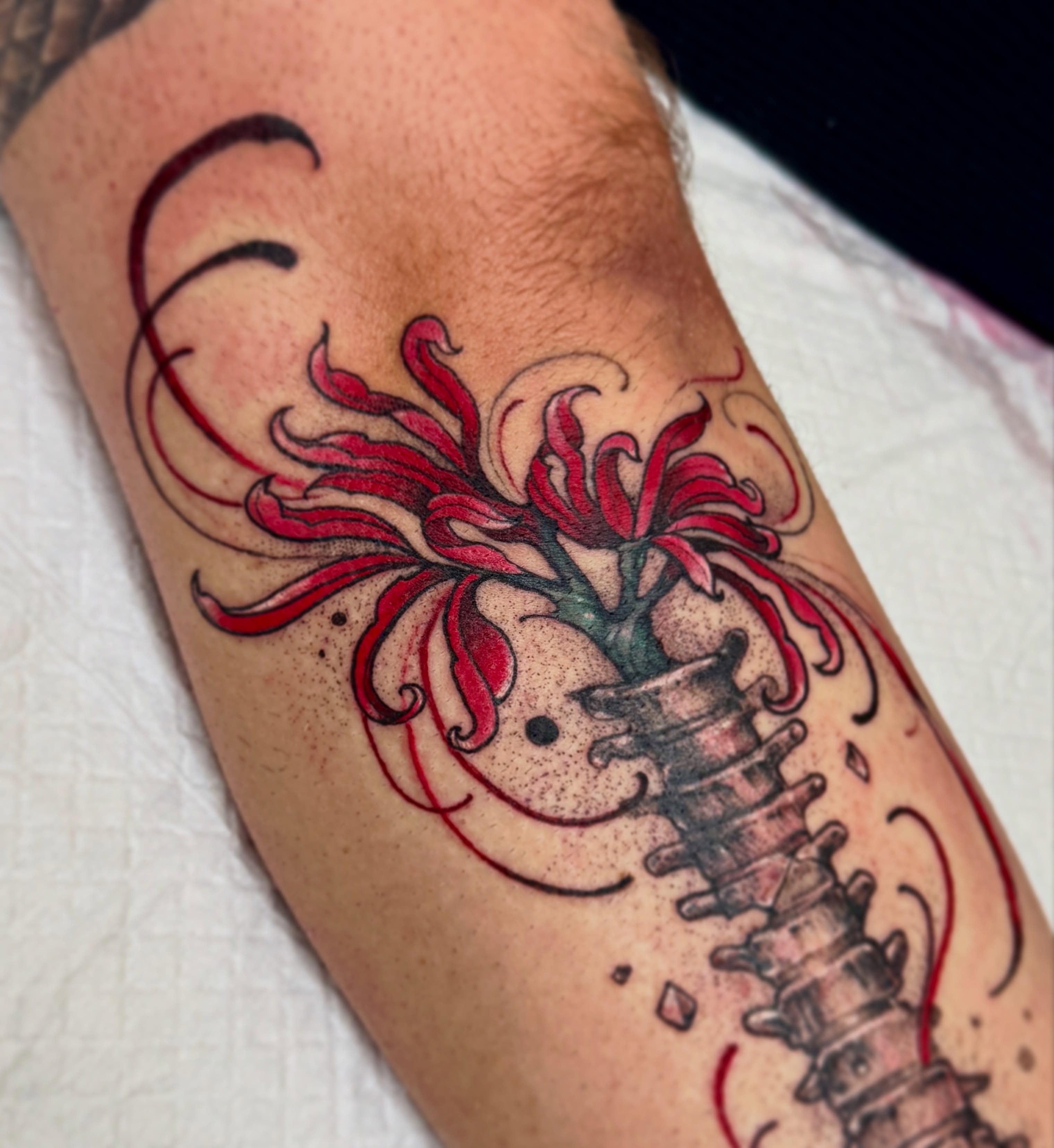 Spine with flower dotwork tattoo on the forearm by Andy Rowe- Tattoo Artist🦇