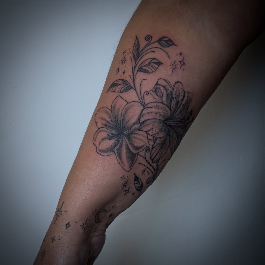 Floral arrangement black and grey tattoo on the forearm by dev