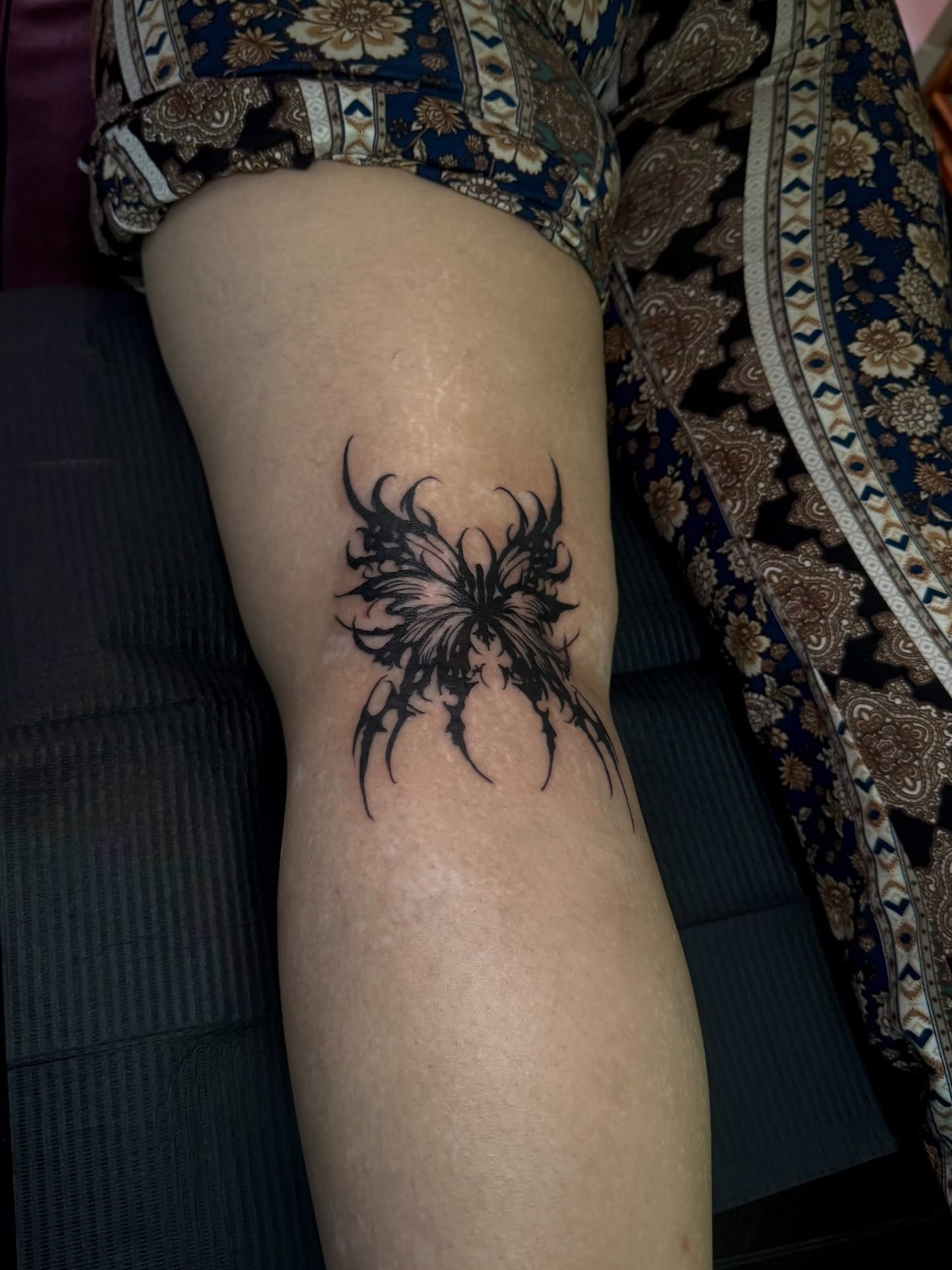 Abstract butterfly black and grey tattoo on the thigh by Angie Cotton