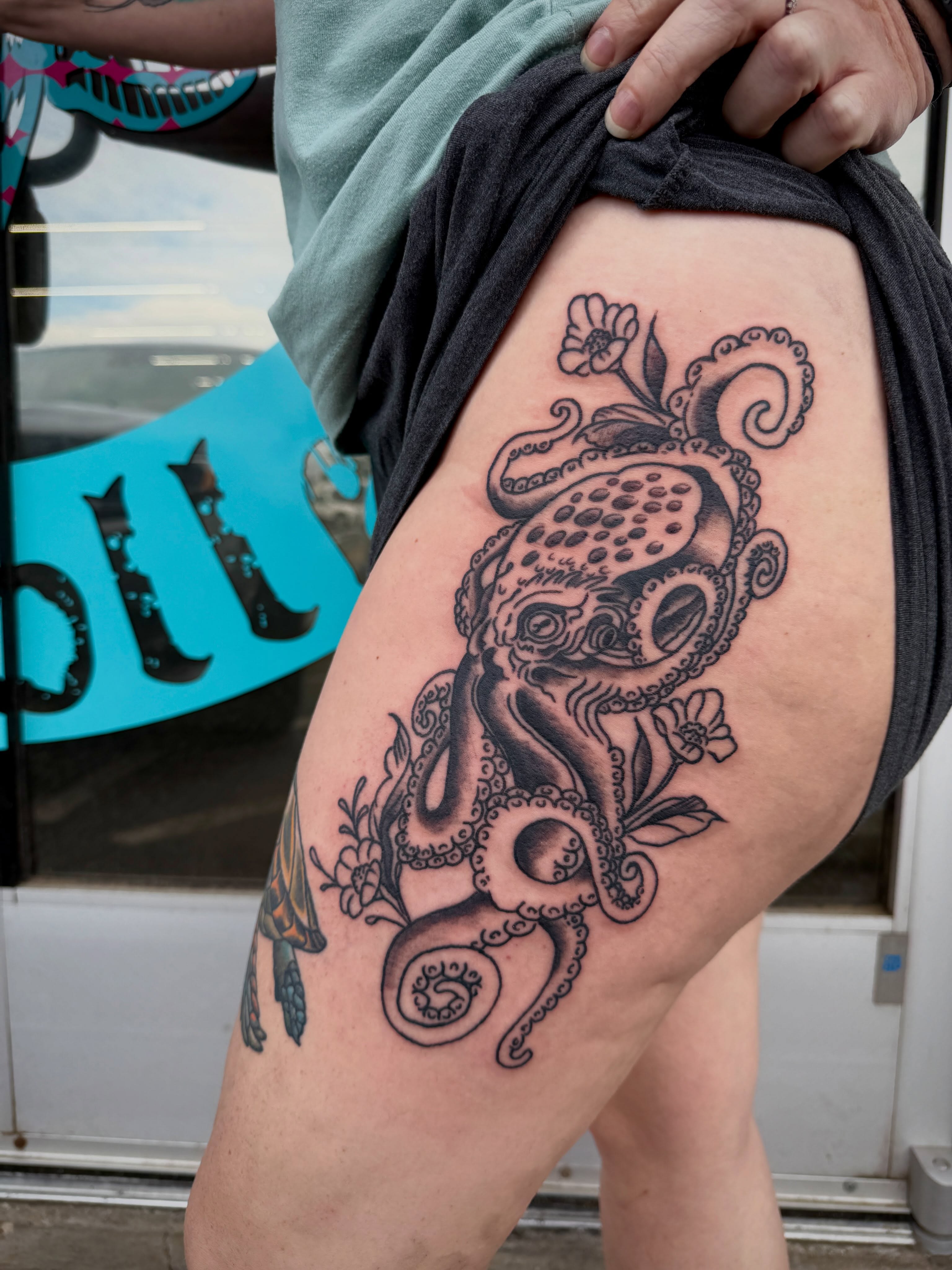 Octopus black and grey tattoo on the thigh by Ali Calis