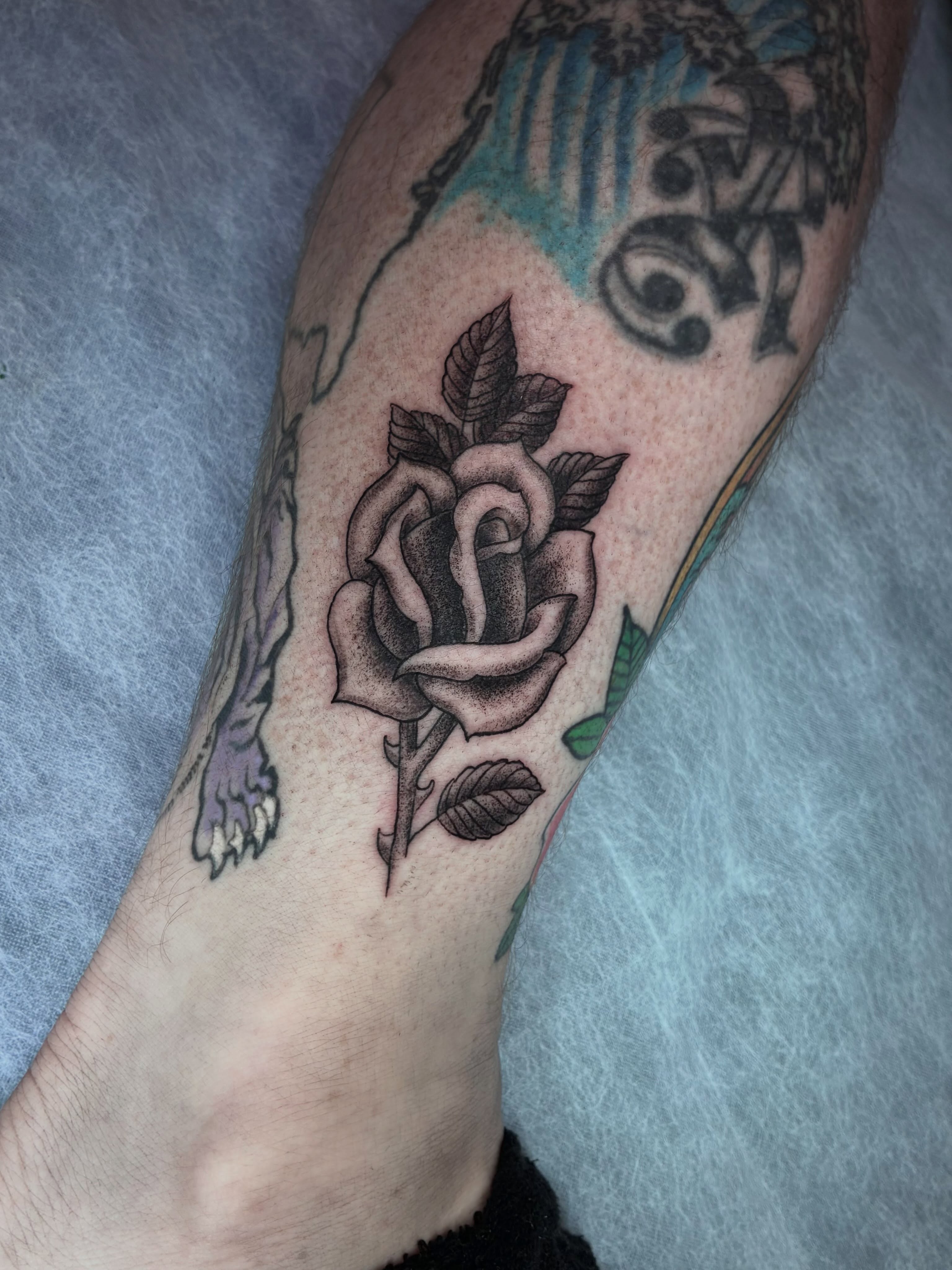 Rose black and grey tattoo on the forearm by Alex Larsen