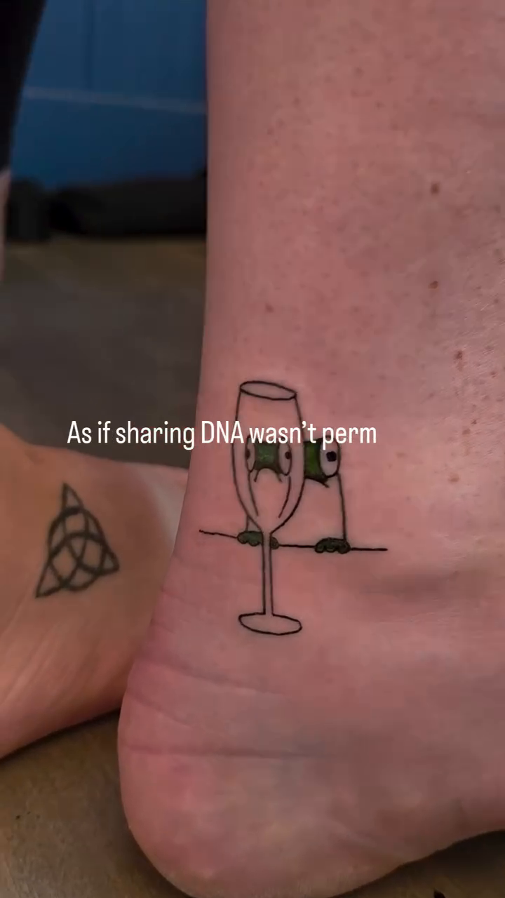 Wine glass and text minimalist tattoo on the foot by Danyelle Becker