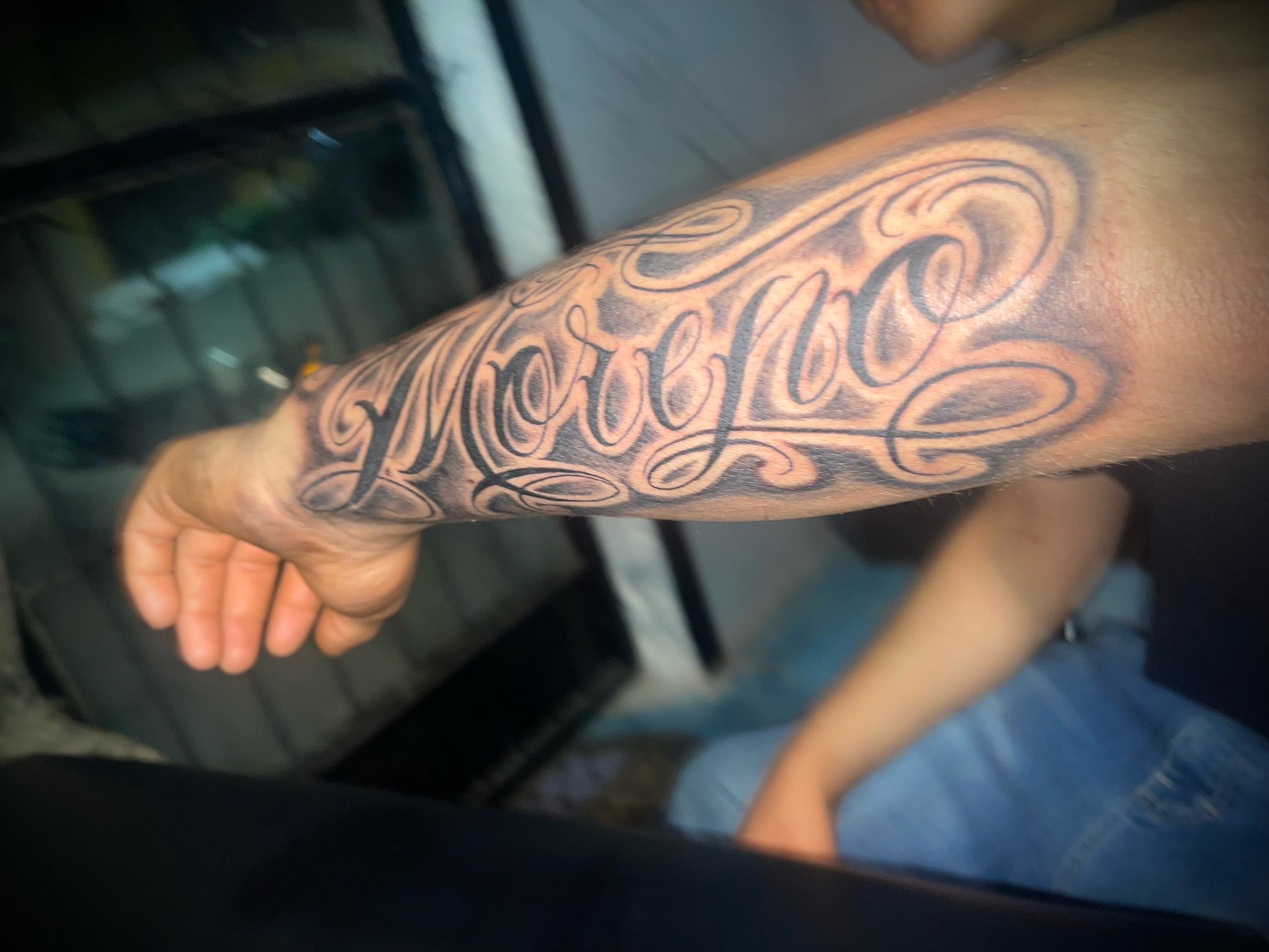 Moreno lettering script tattoo on the forearm by Tu SanchoTattoos