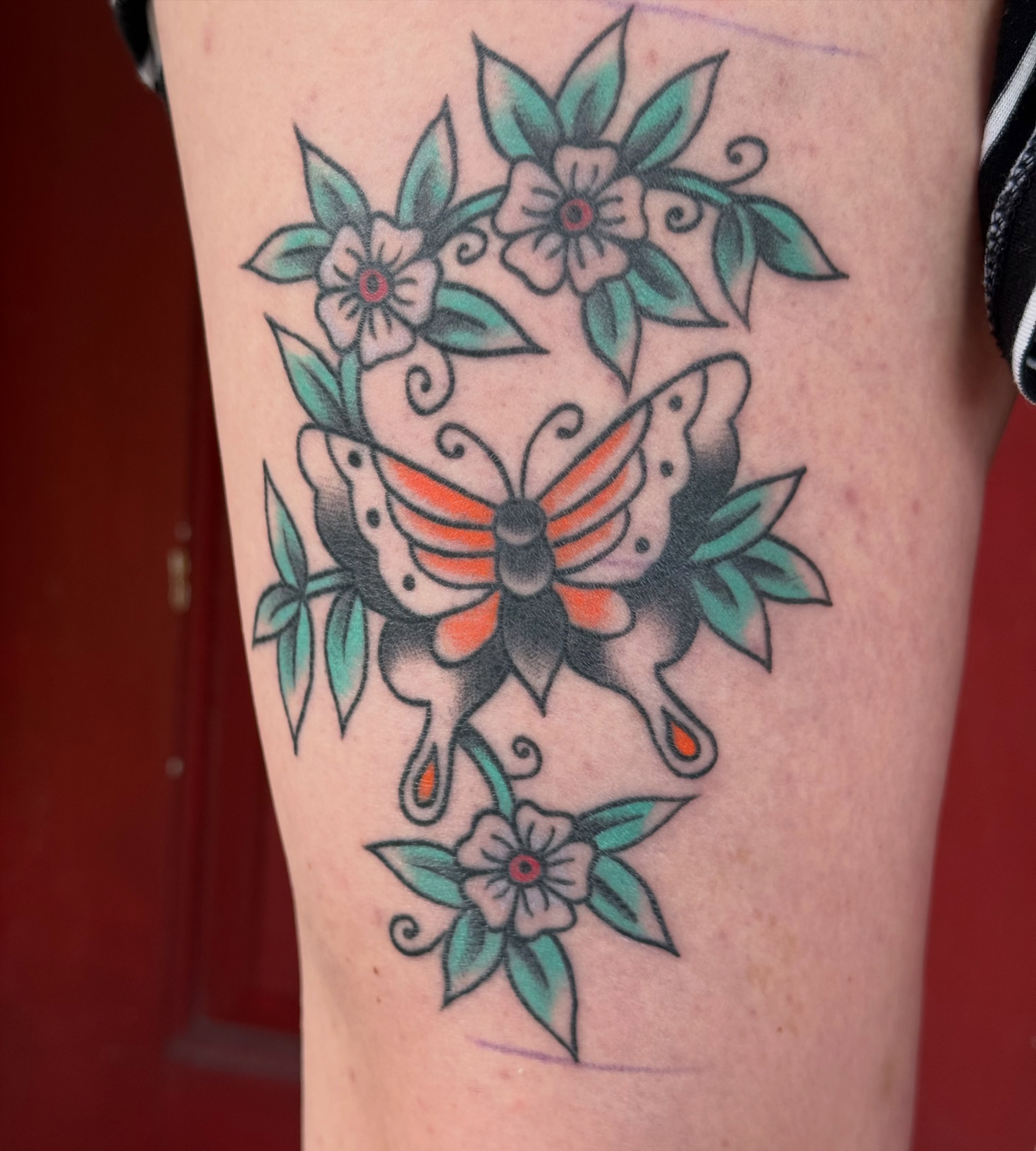 Butterfly and flowers American traditional tattoo on the forearm by Kaysen