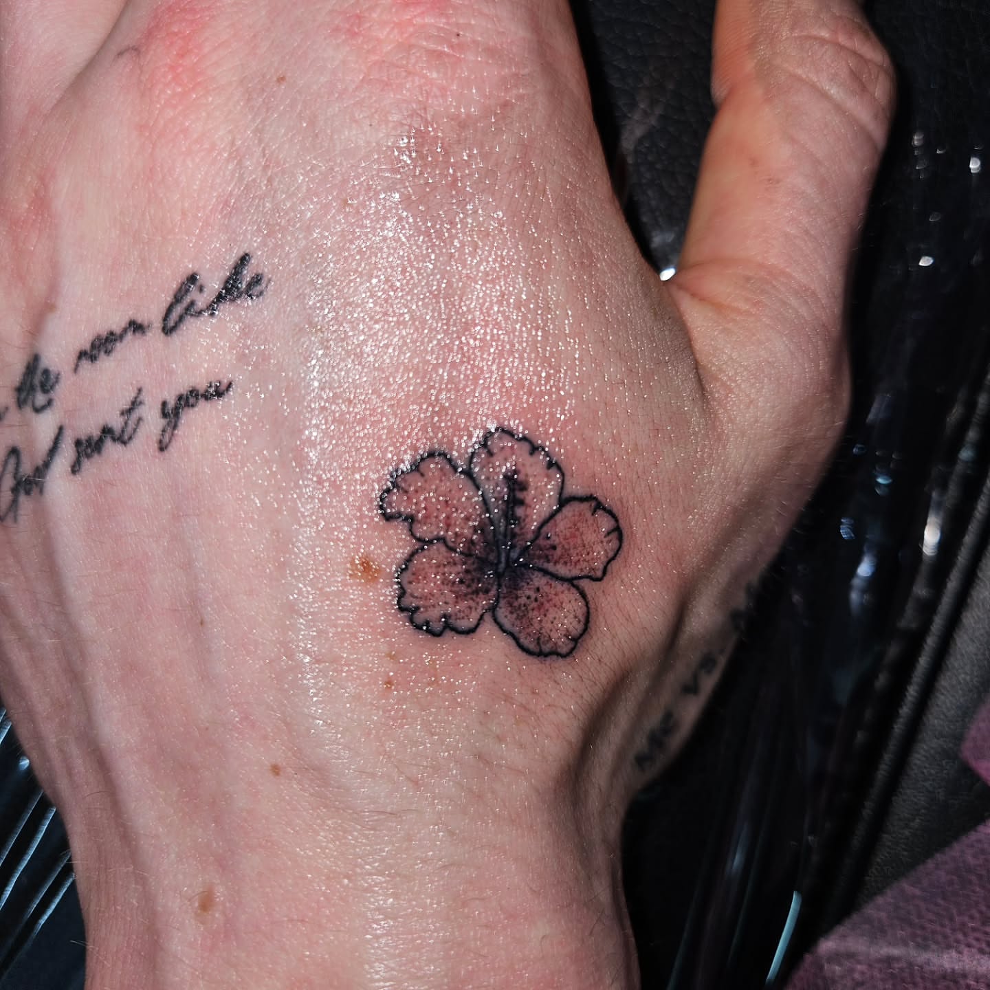Flower black and grey tattoo on the hand by Mischief π€