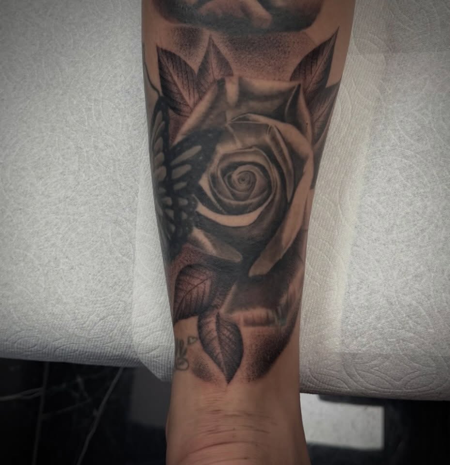 Rose realism tattoo on the forearm by Amber Lynn