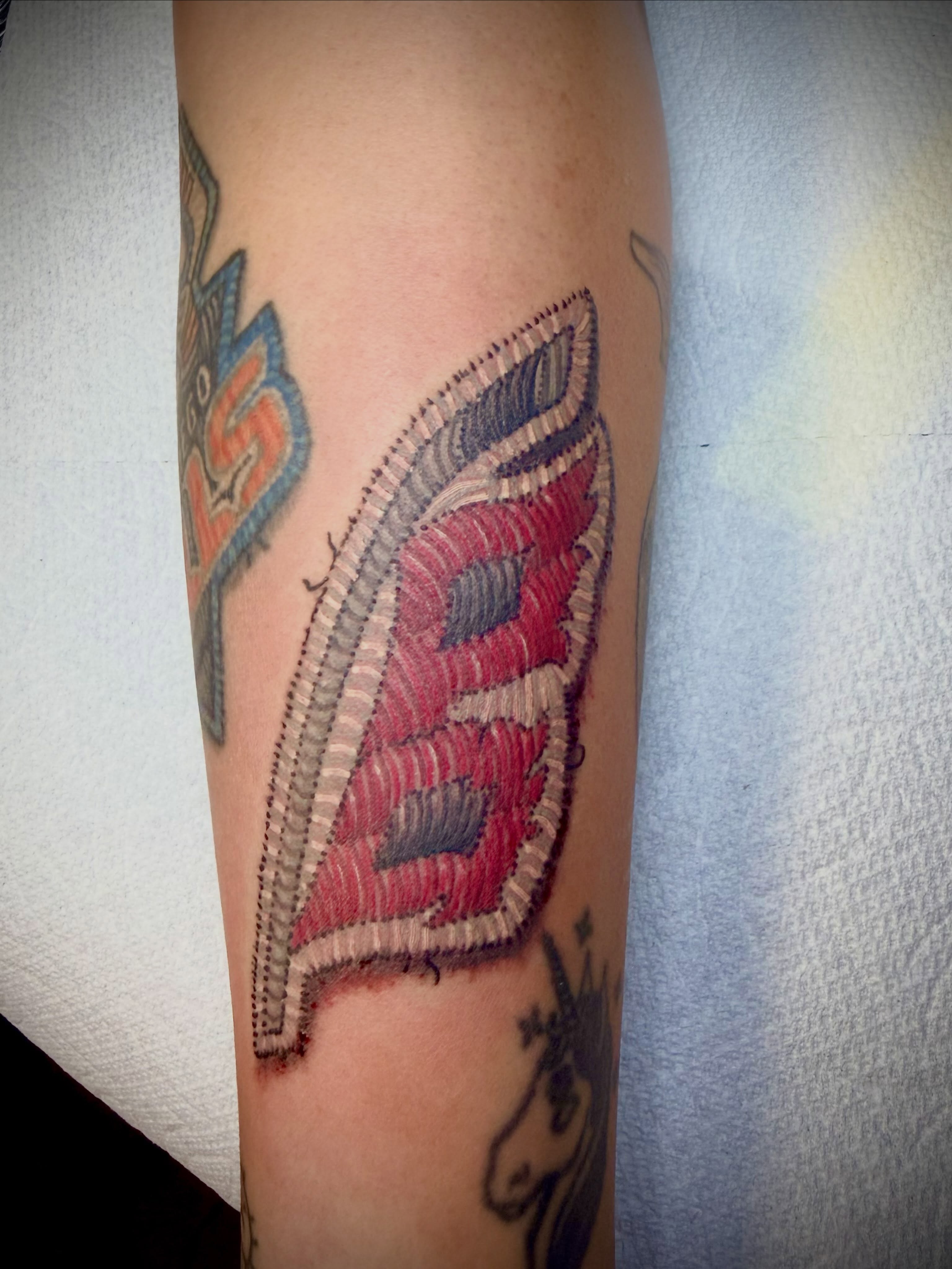 Embroidered letter tattoo on the forearm by San Diego Tattoo Artist