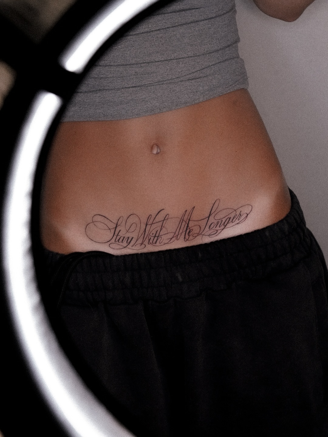 Stay with me longer lettering script tattoo on the torso by Joy Christiana