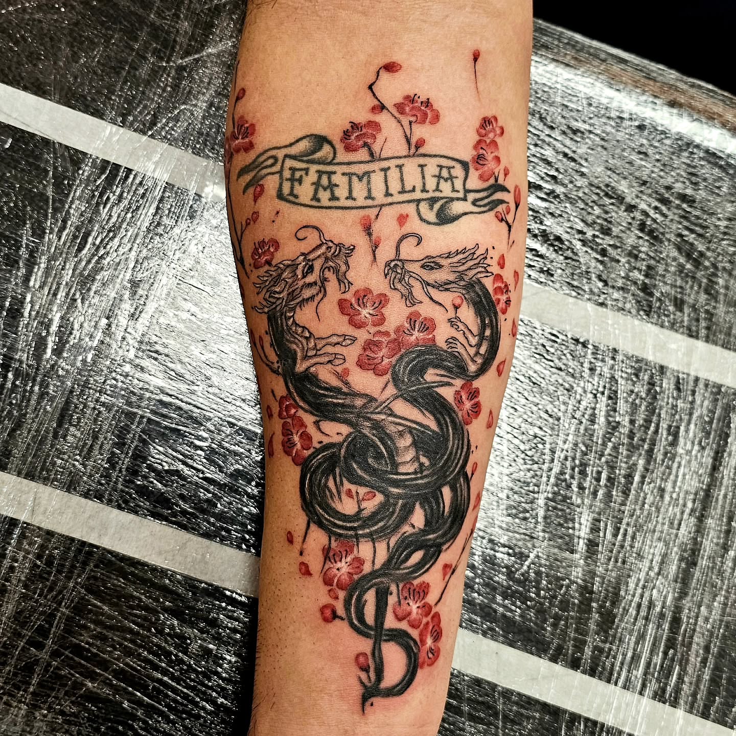 Dragon and cherry blossoms japanese irezumi tattoo on the forearm by Lili Gu