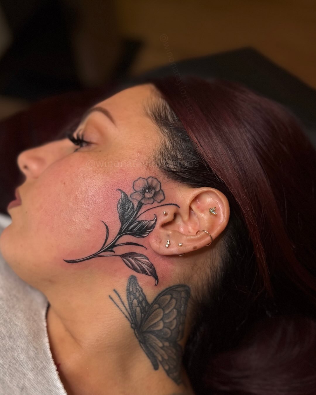 Flower and butterfly black and grey tattoo on the neck by 𝒲𝒾𝓃𝑜𝓃𝒶