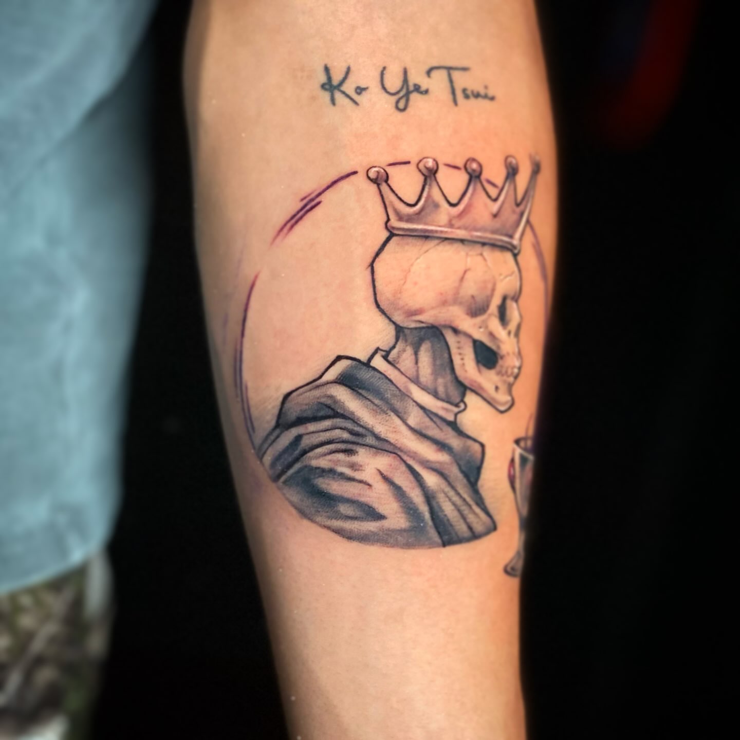 Skull wearing crown black and grey tattoo on the forearm by Picasso Dular, Lake Forest, California