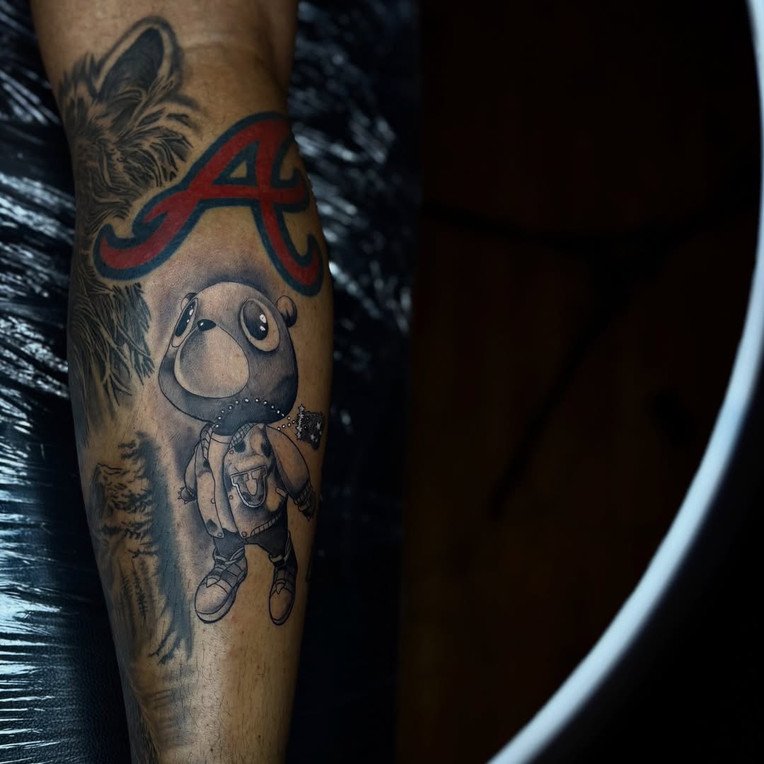 Chibi character black and grey tattoo on the forearm by Koolz