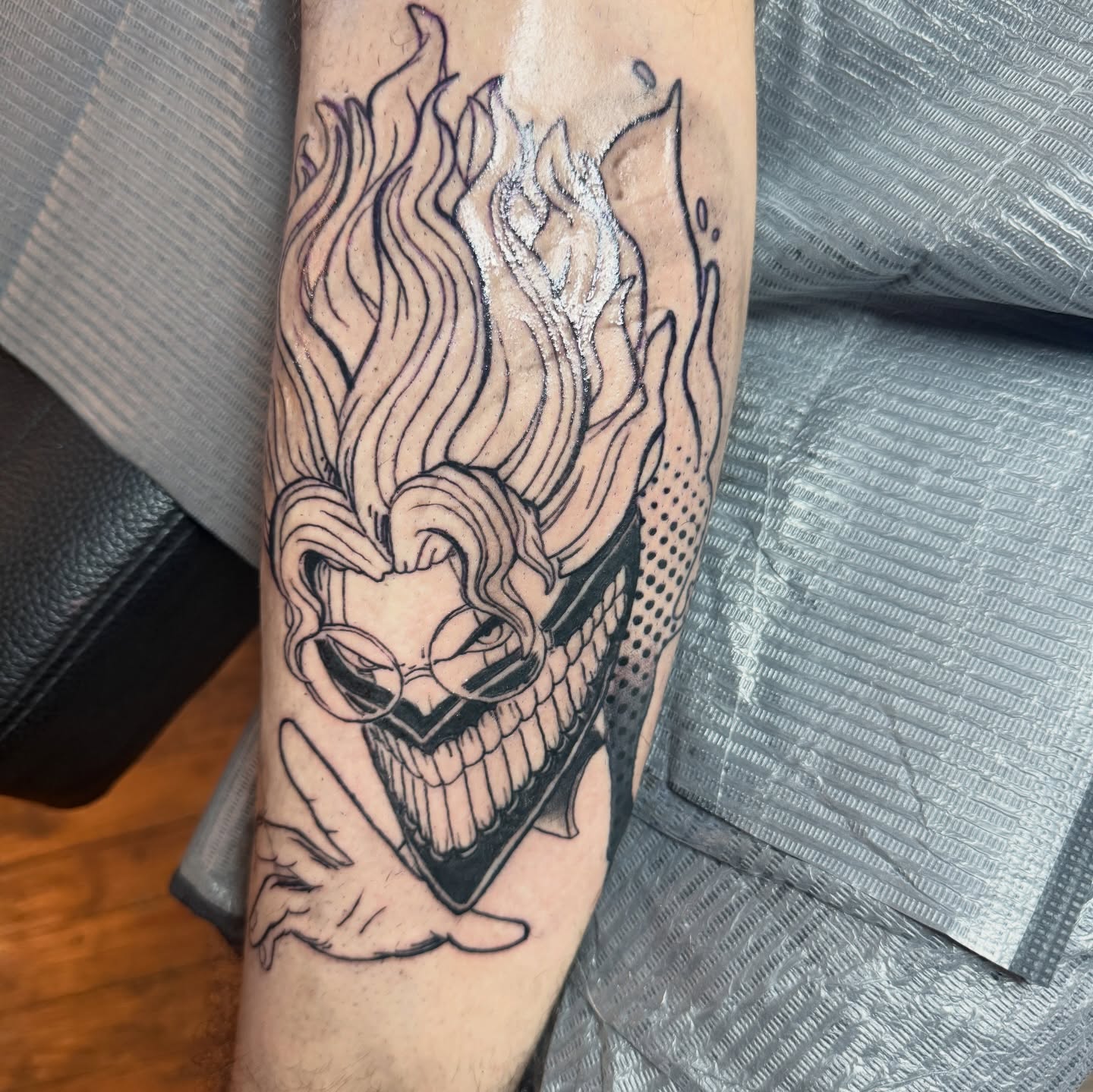 Clown black and grey tattoo on the forearm by Eric Burns - NoVA Tattoo Artist