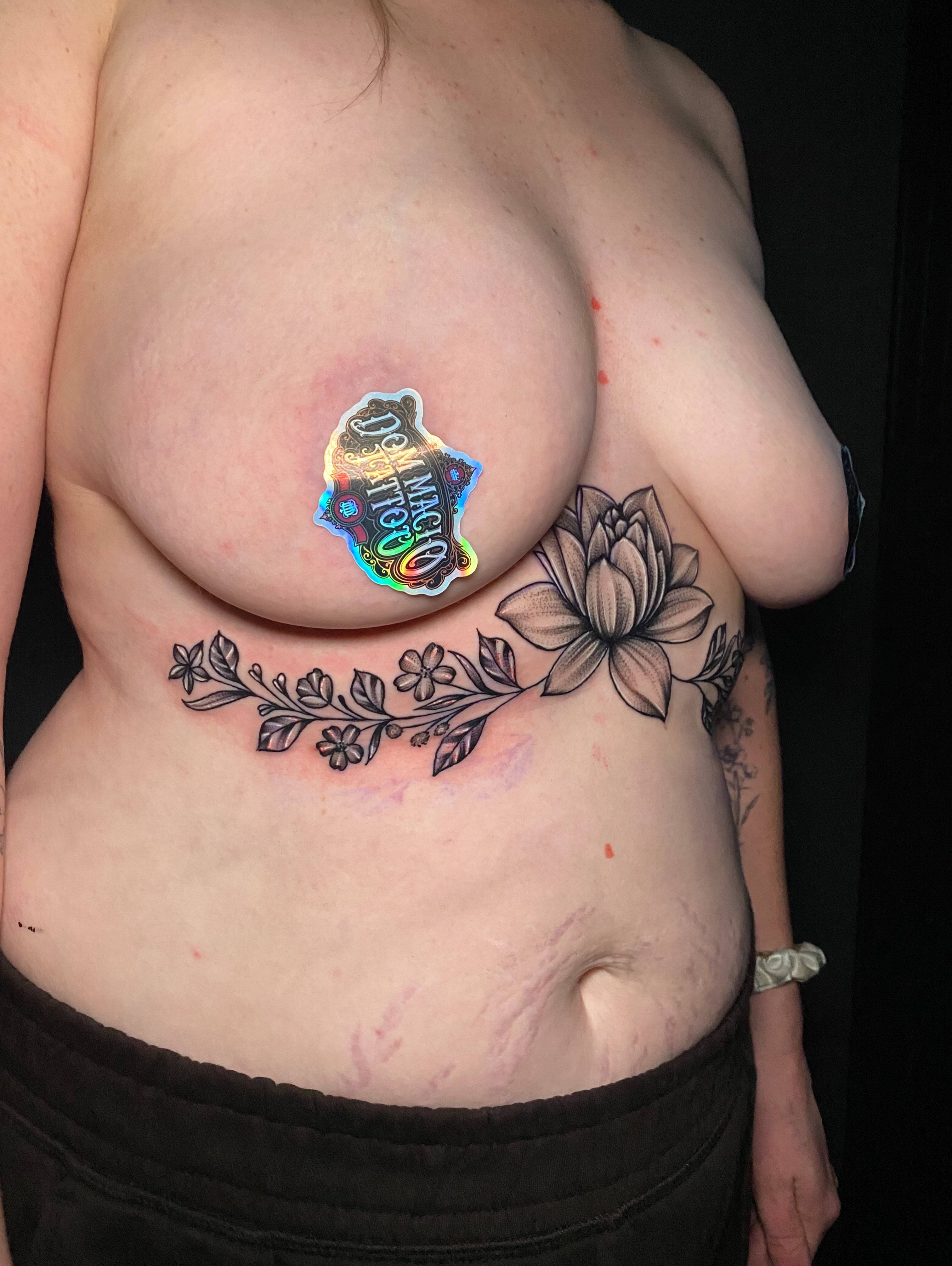 Lotus flower black and grey tattoo on the chest by @dom_macio_tattoo