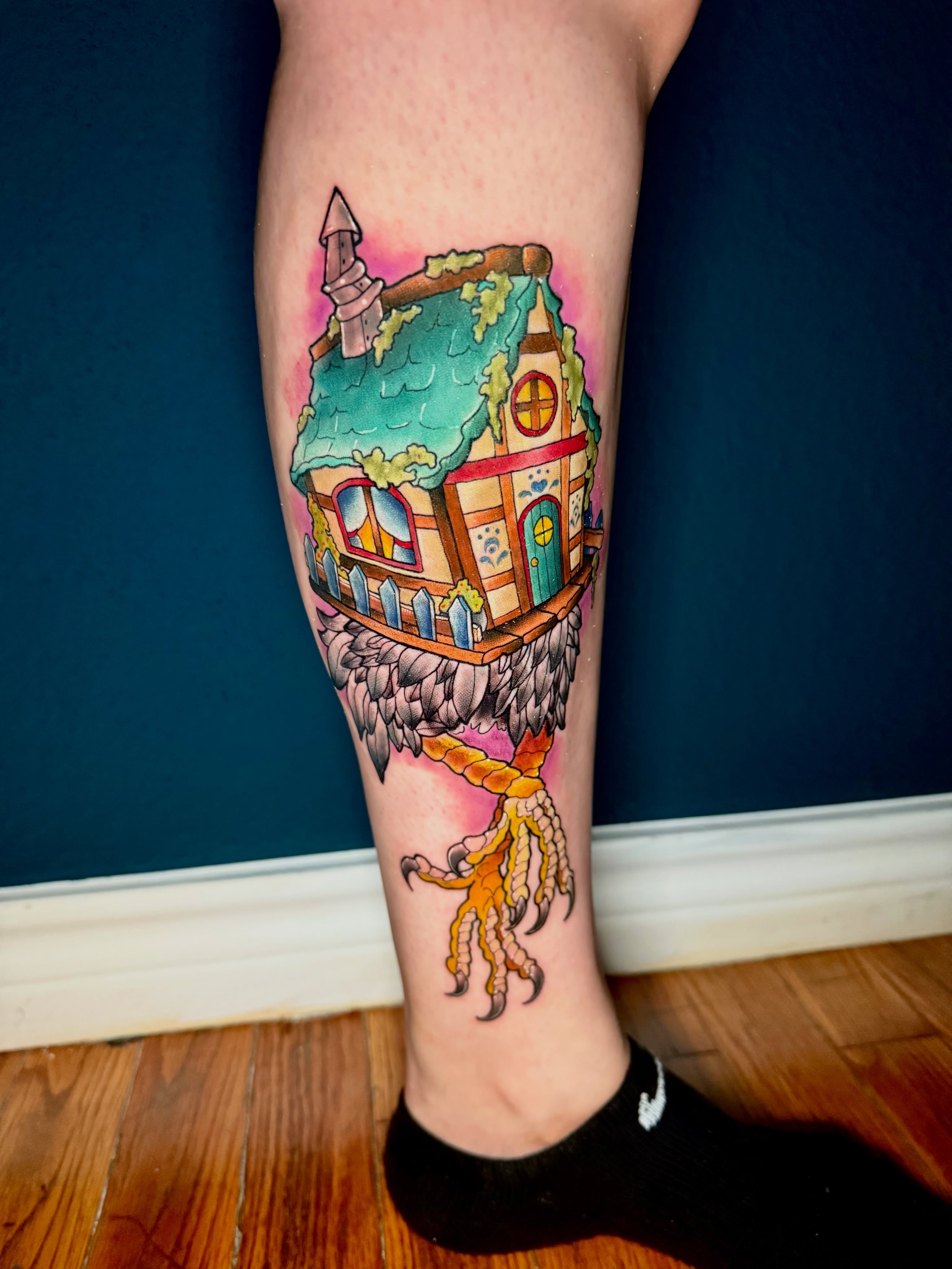 House on bird watercolor tattoo on the calf by Erin Peterson