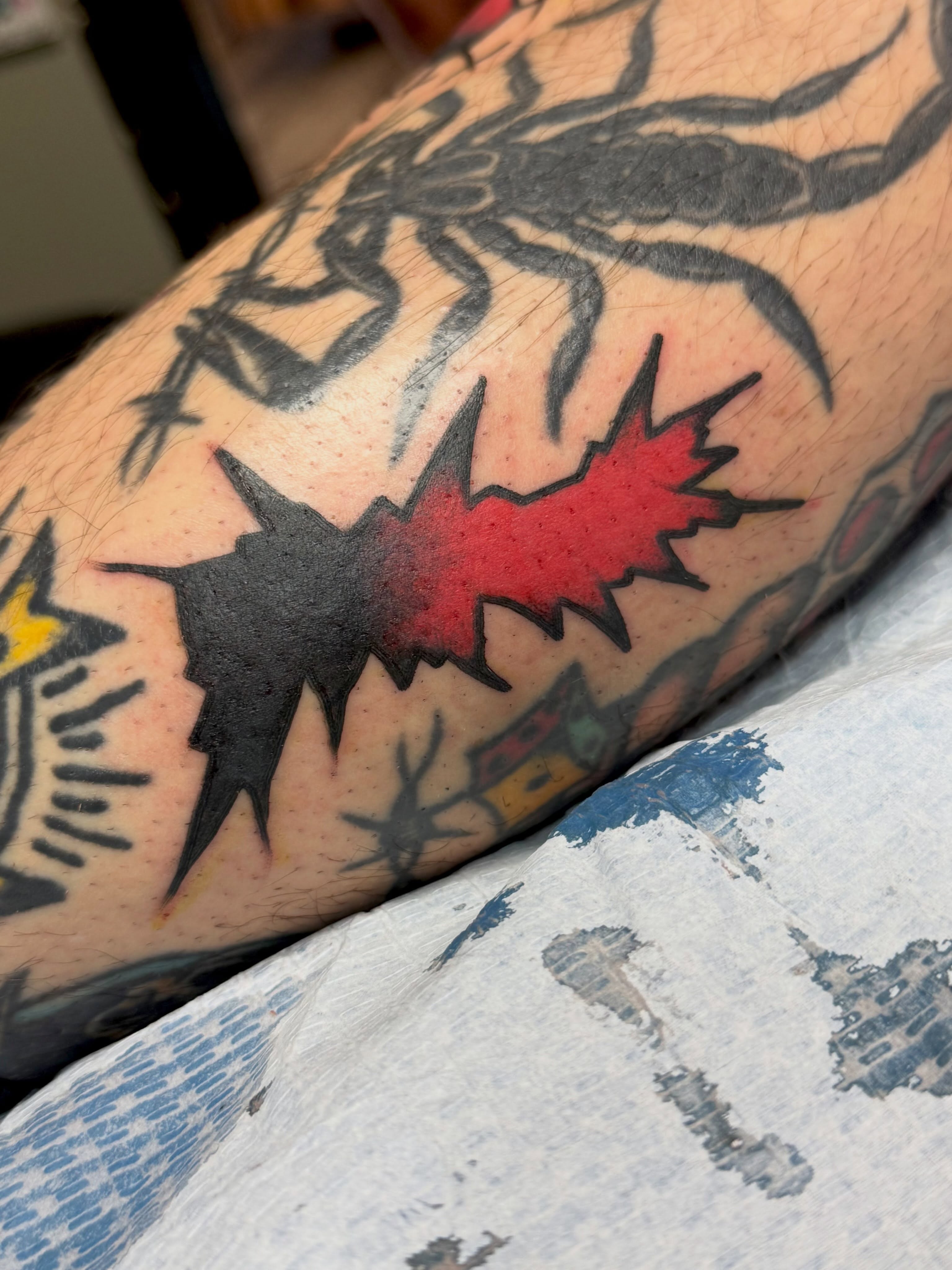 Red and black spiky shape American traditional tattoo on the forearm by KevinBetsch