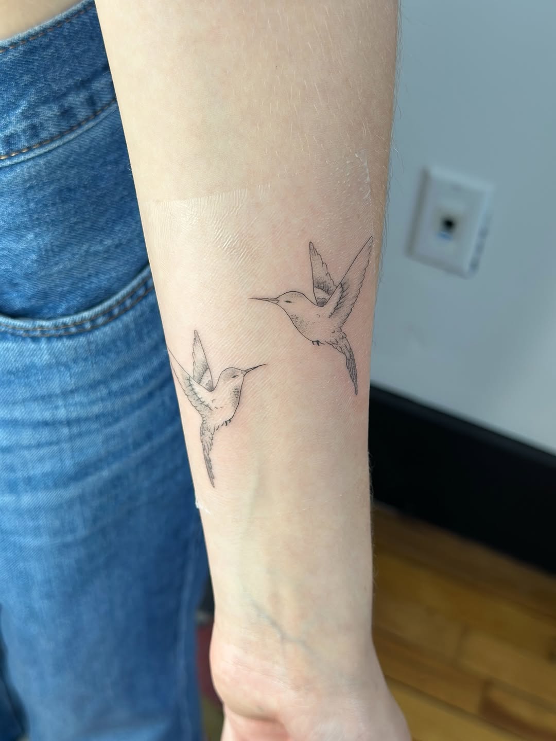 Two hummingbirds fine line tattoo on the forearm by Cherry🥀