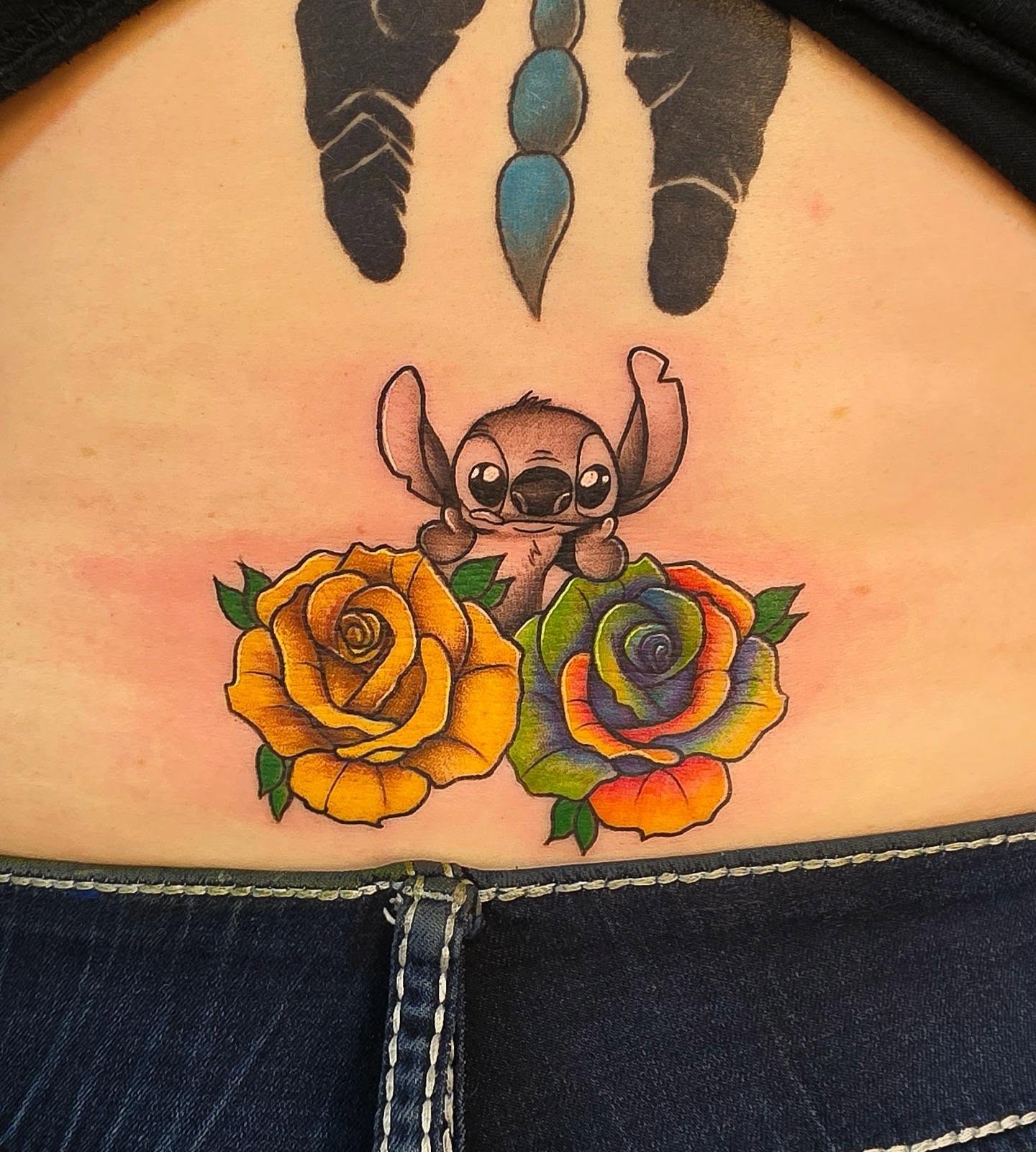 Stitch and roses American traditional tattoo on the thigh by Danielle Elizabeth