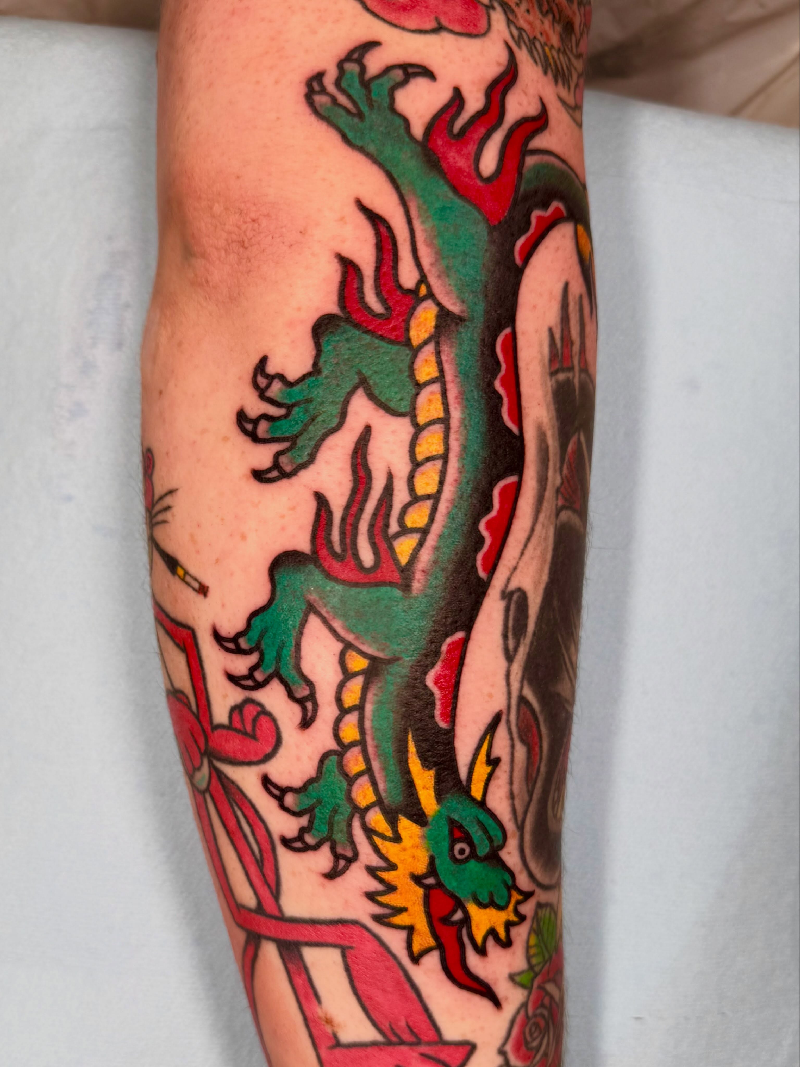Dragon and skull American traditional tattoo on the forearm by Henry Bubula, Minneapolis, Minnesota