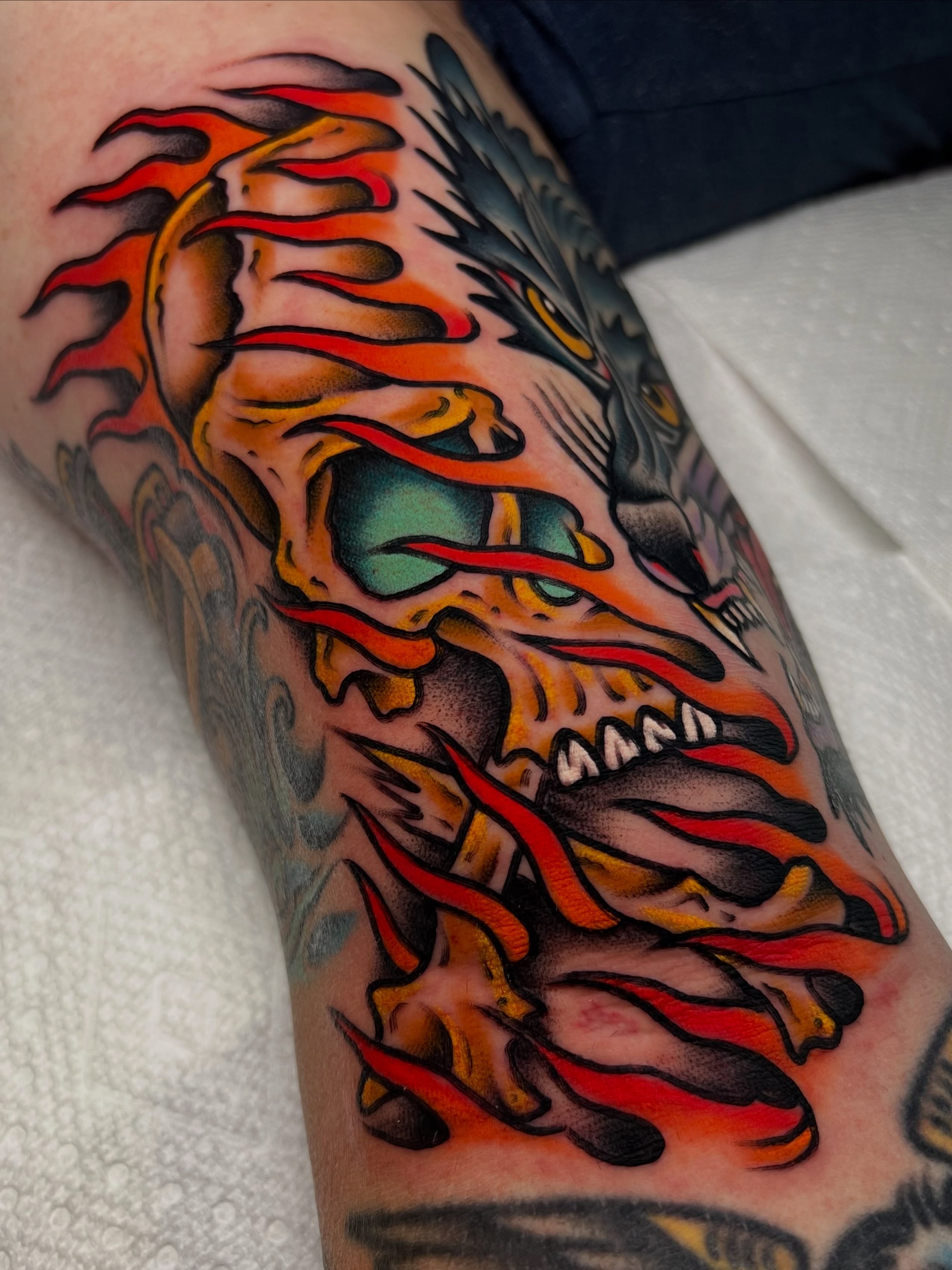 Flaming dragon American traditional tattoo on the forearm by ᴍᴀᴛᴛ ᴀʟᴇxᴀɴᴅᴇʀ