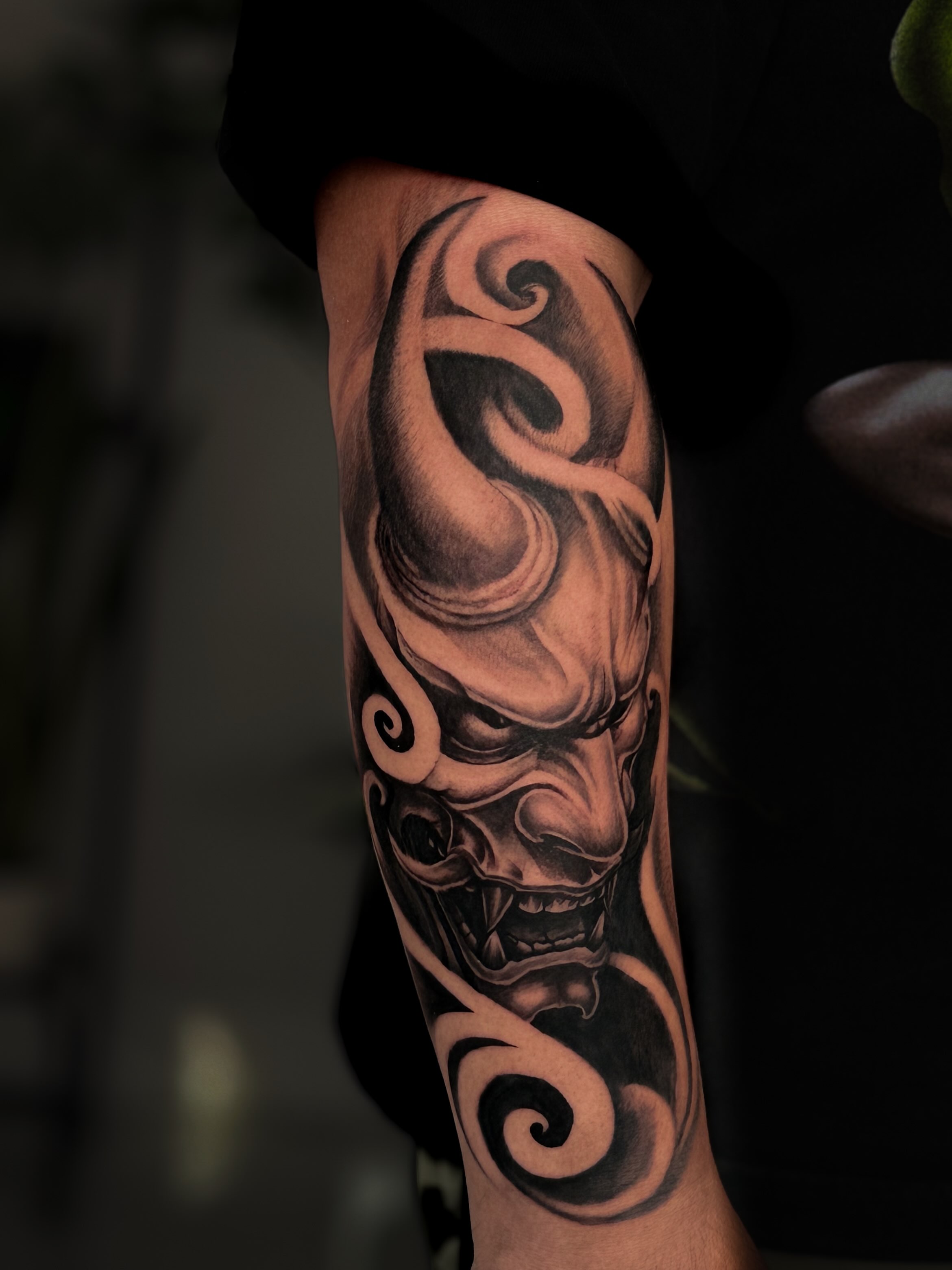 Demon mask realism tattoo on the forearm by Kai, Charlotte, North Carolina