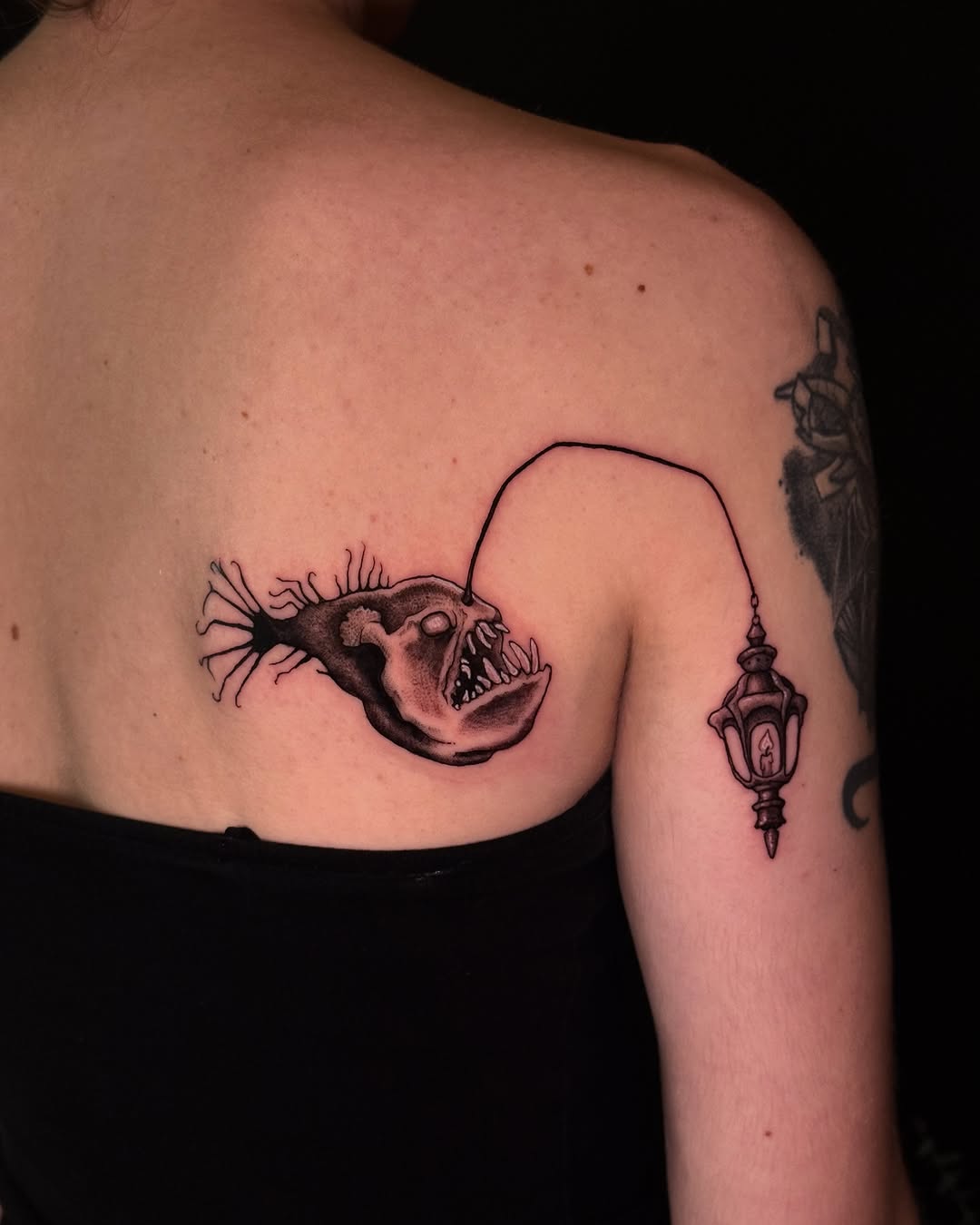 Anglerfish with lantern fine line tattoo on the back by marlena borscheid