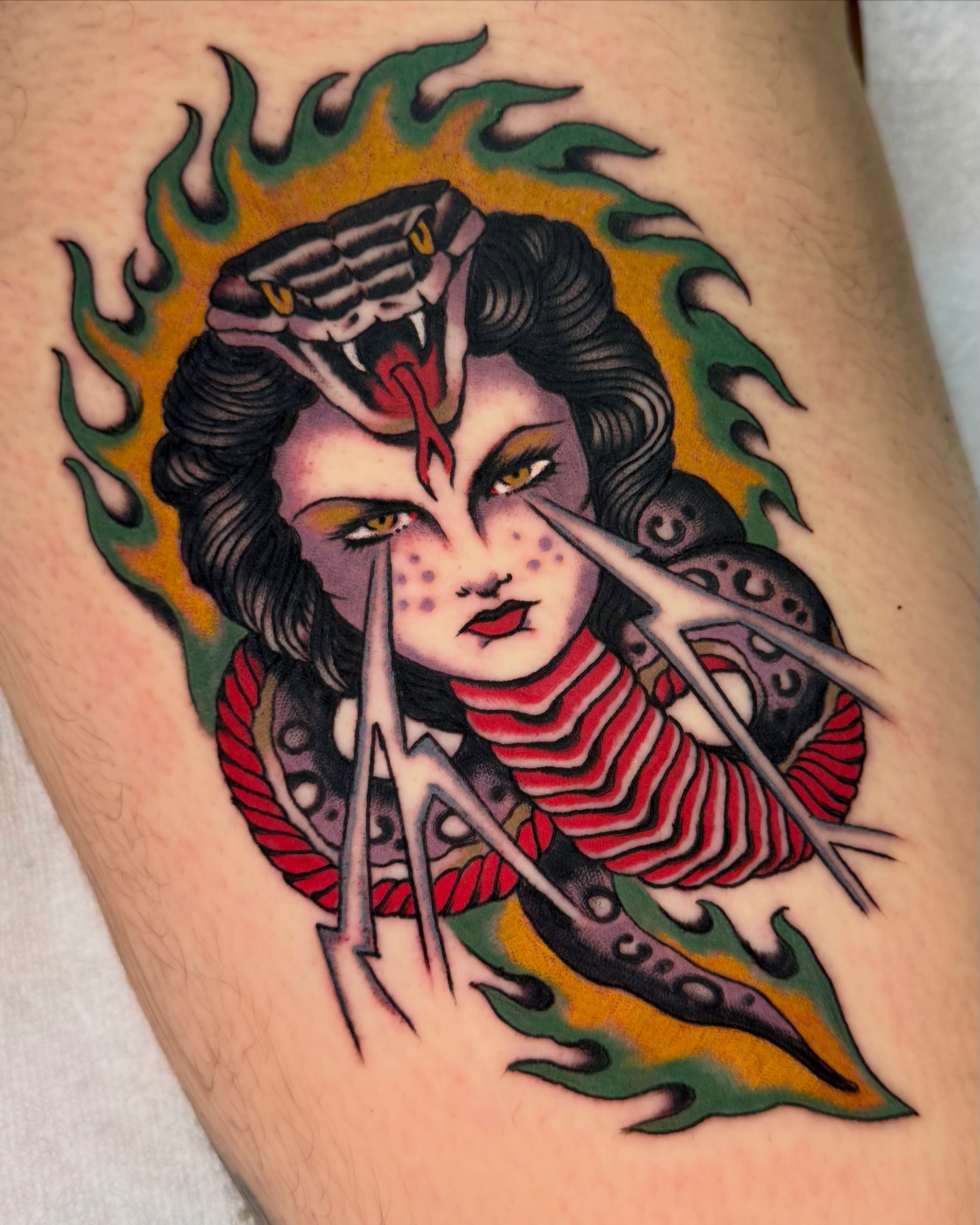 Woman with snake American traditional tattoo on the thigh by Haley Tucker, Sebastopol, California