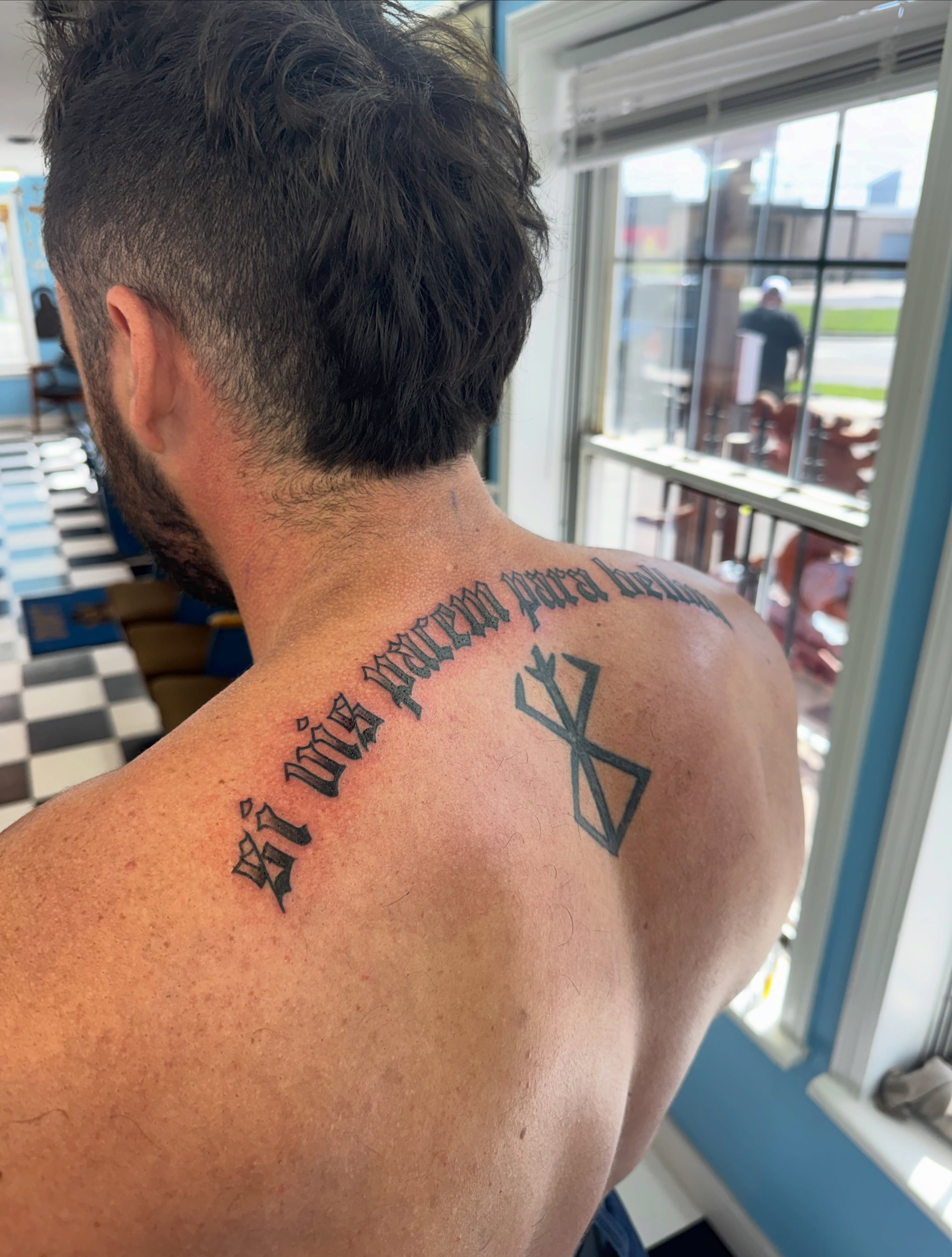 Geometric symbol with text geometric tattoo on the back by Béle Benard
