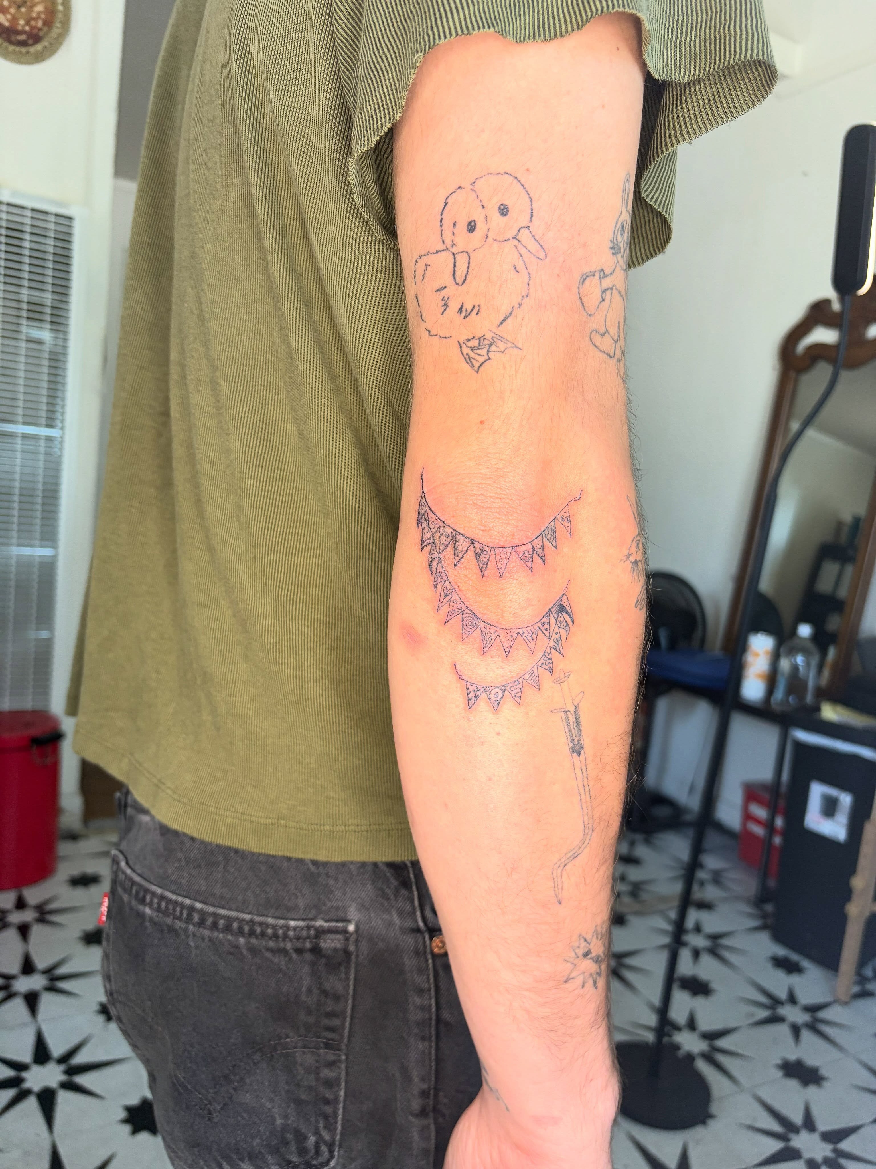 Ducks and crescent moons American traditional tattoo on the forearm by Mattie Robinson