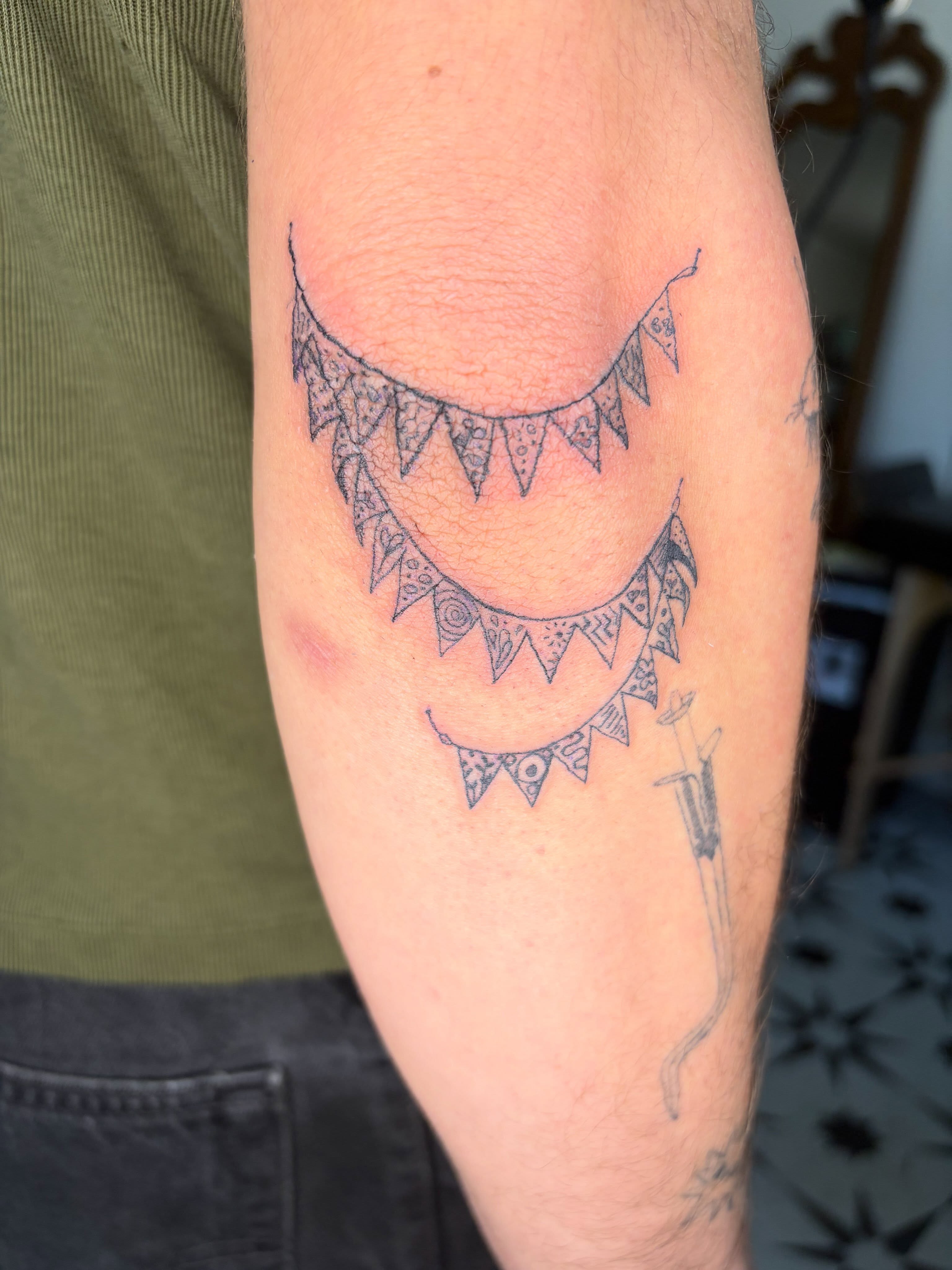 Geometric crescent moons geometric tattoo on the forearm by Mattie Robinson