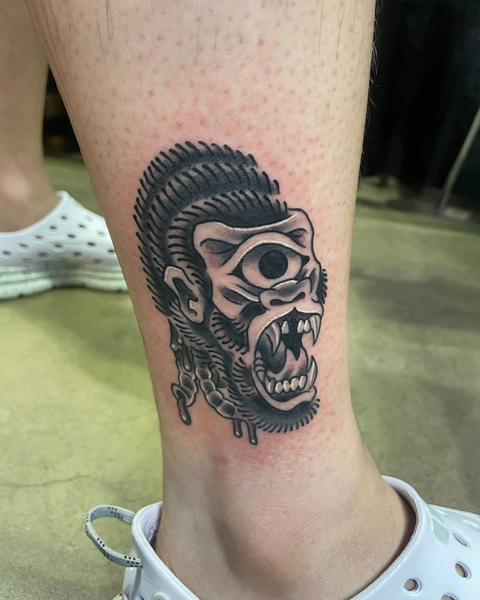 Angry skull black and grey tattoo on the calf by Auzzy the Ink Pirate, Mansfield, Ohio