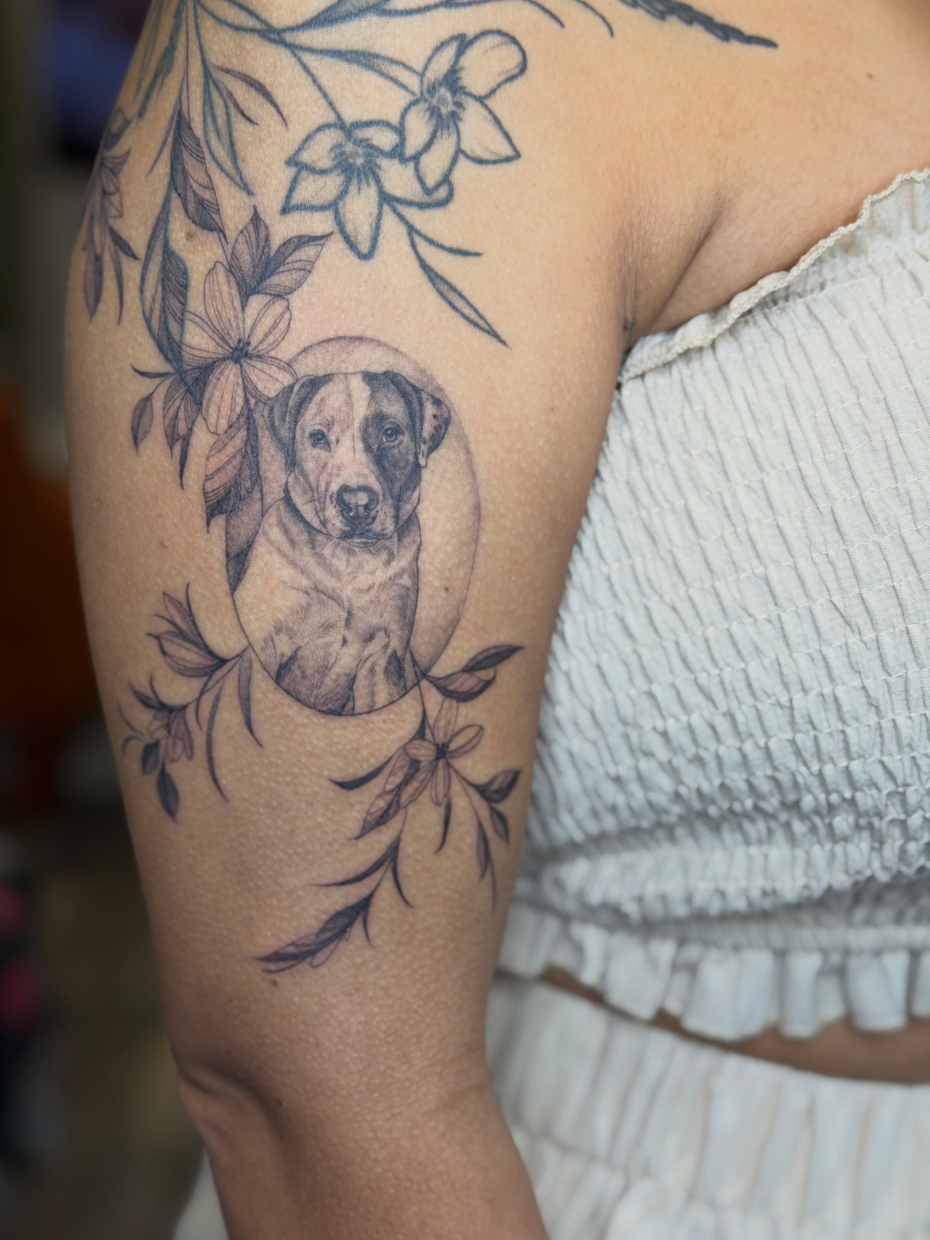 Dog portrait realism tattoo on the upper arm by Melissa Rose Moya