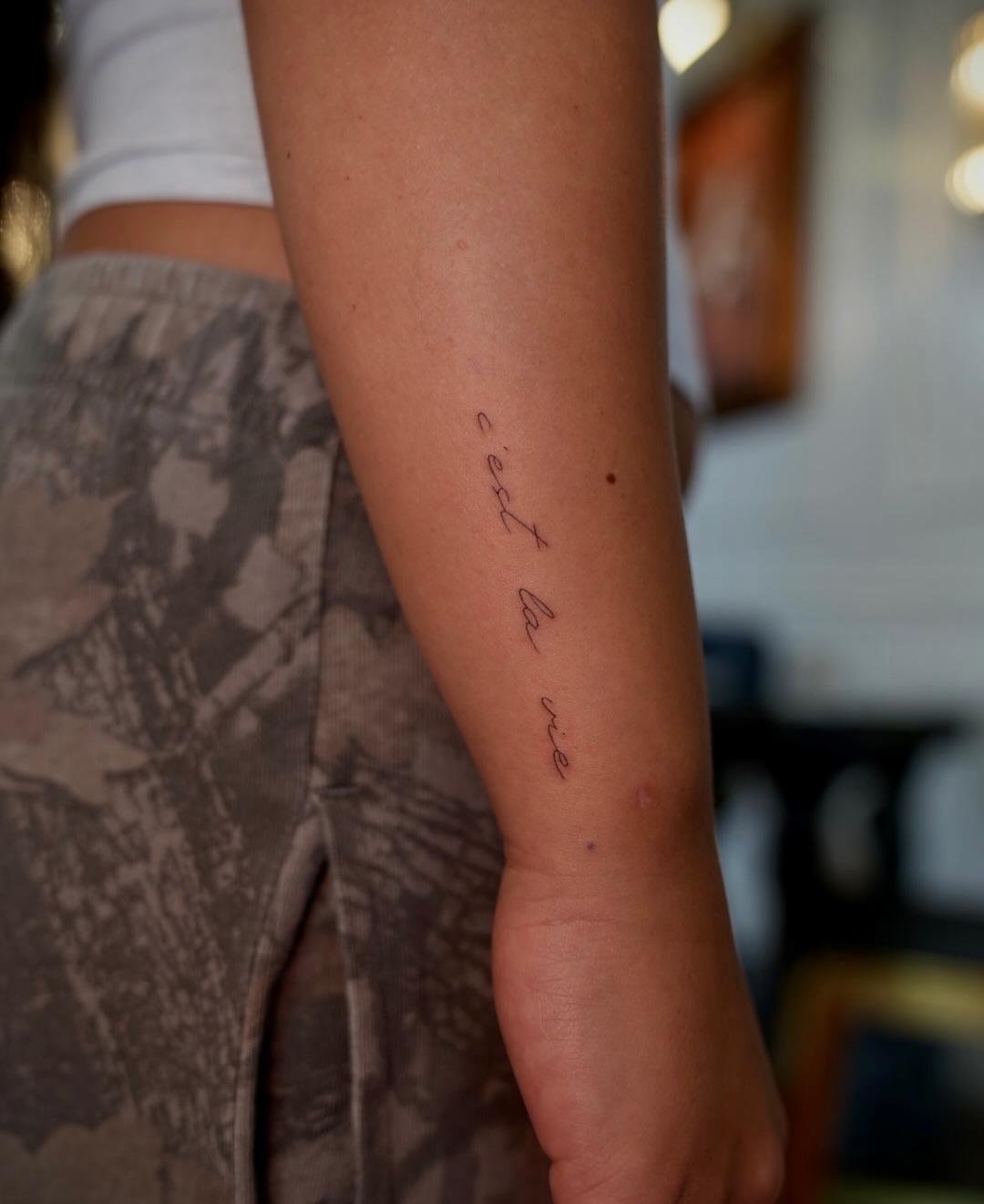 C'est la vie lettering script tattoo on the forearm by 🤍 Sarah 🖤
